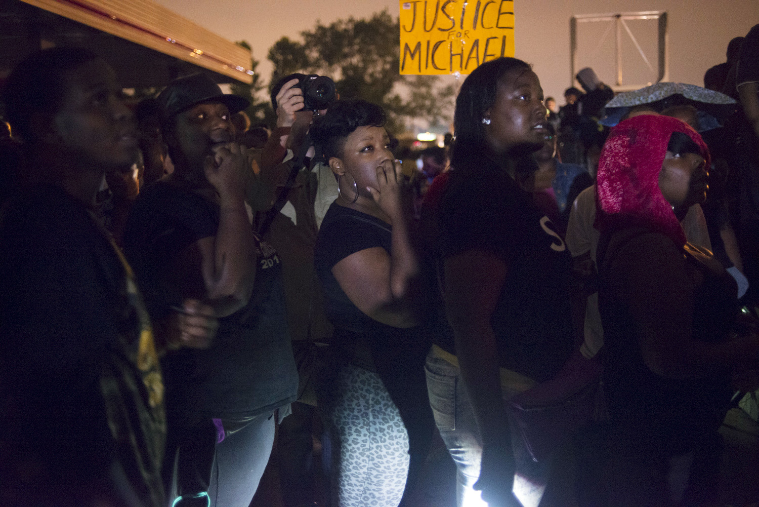 Protestors look on during a peaceful demonstration on Florissant Ave. in Ferguson, Mo. on Aug. 16, 2014. (Jon Lowenstein—Noor for TIME)