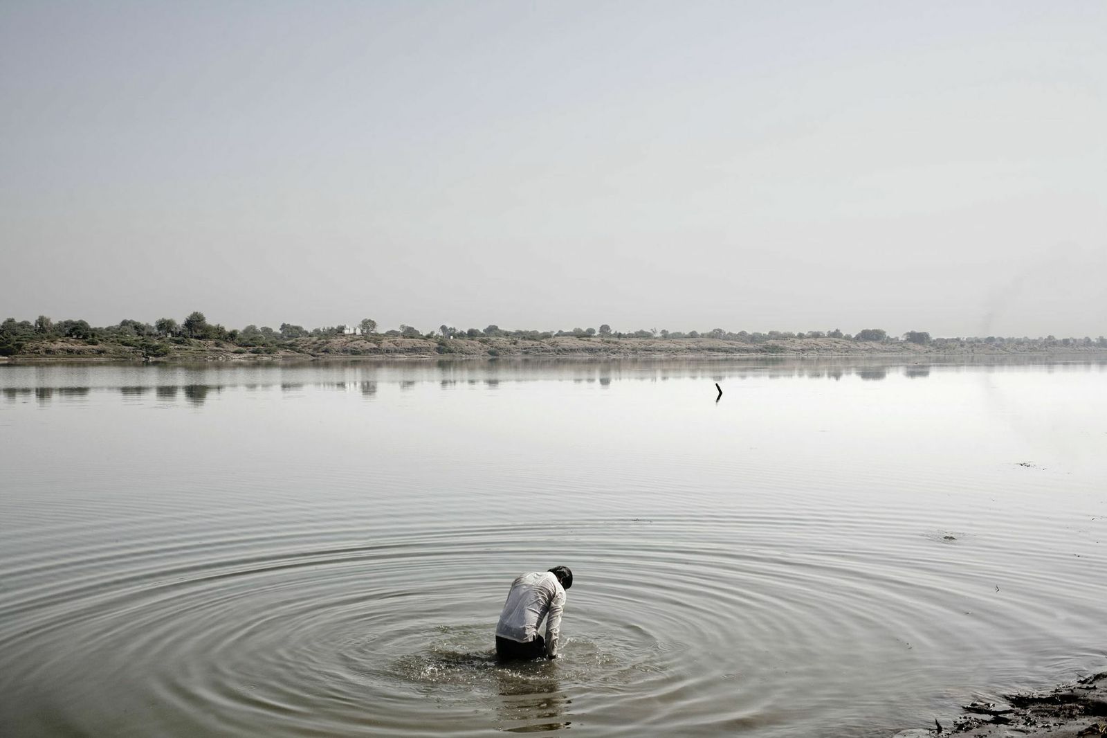 A Hindu man performs a religious ritual in the waters near Varanasi, India, 2008.