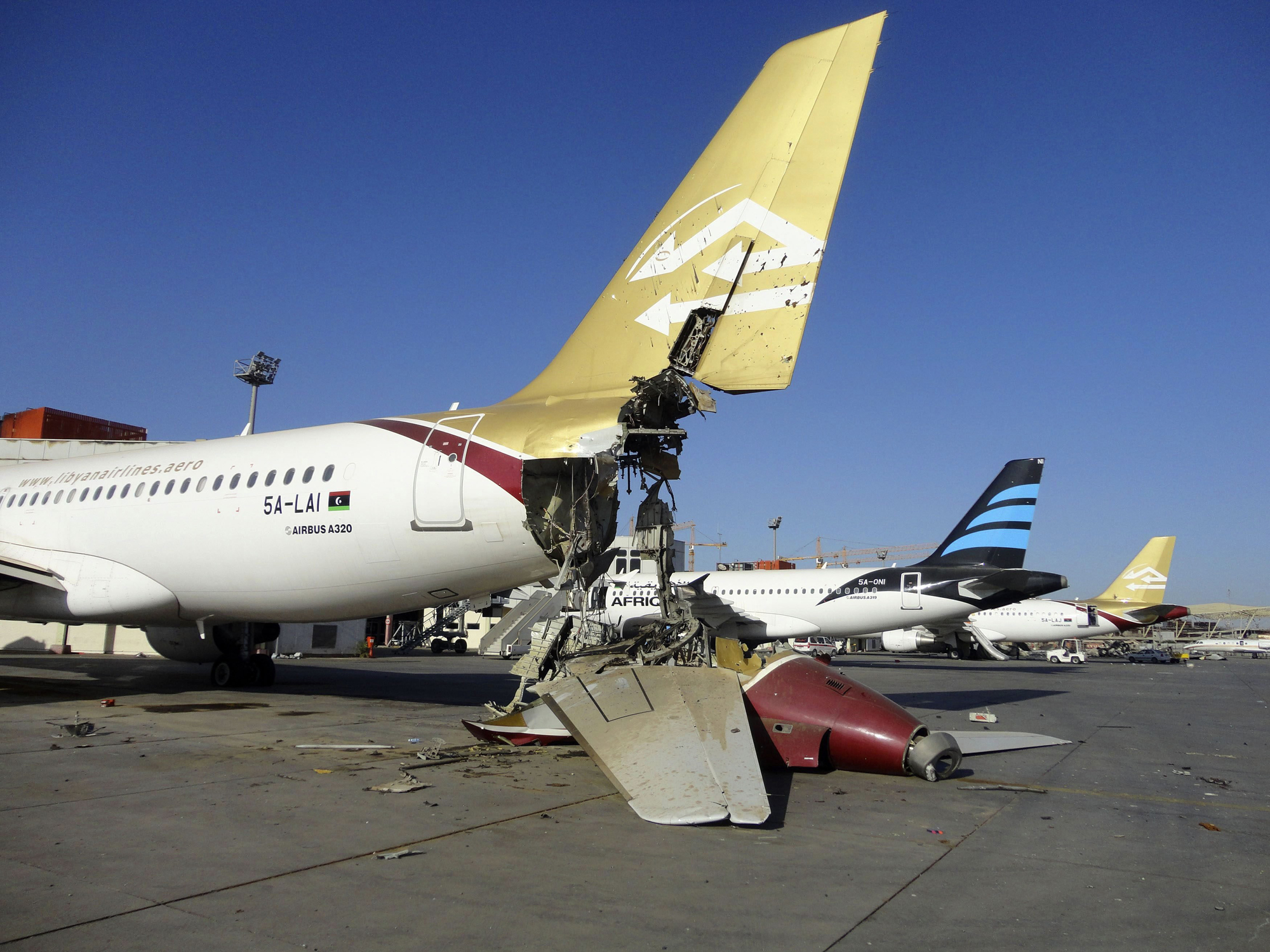 A damaged aircraft is pictured after shelling at Tripoli International Airport, Aug. 24, 2014.