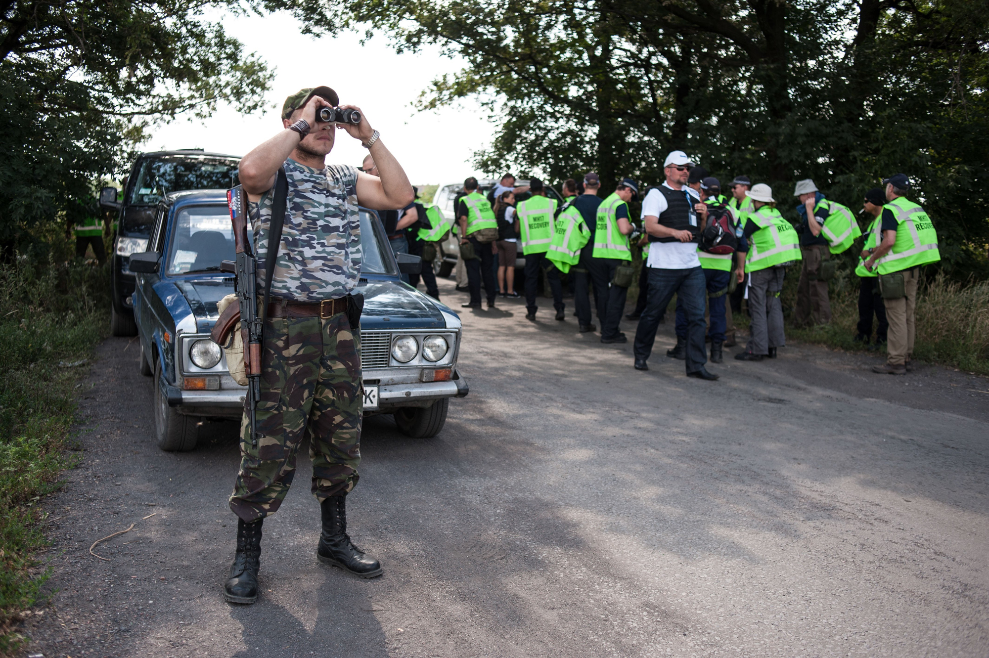 A pro-Russian guards the road as Australian, Malaysian and Dutch investigators prepare to examine the area of the downed Malaysia Airlines Flight 17, near the village of Rossipne, Donetsk region, eastern Ukraine on August 5, 2014. (AP)