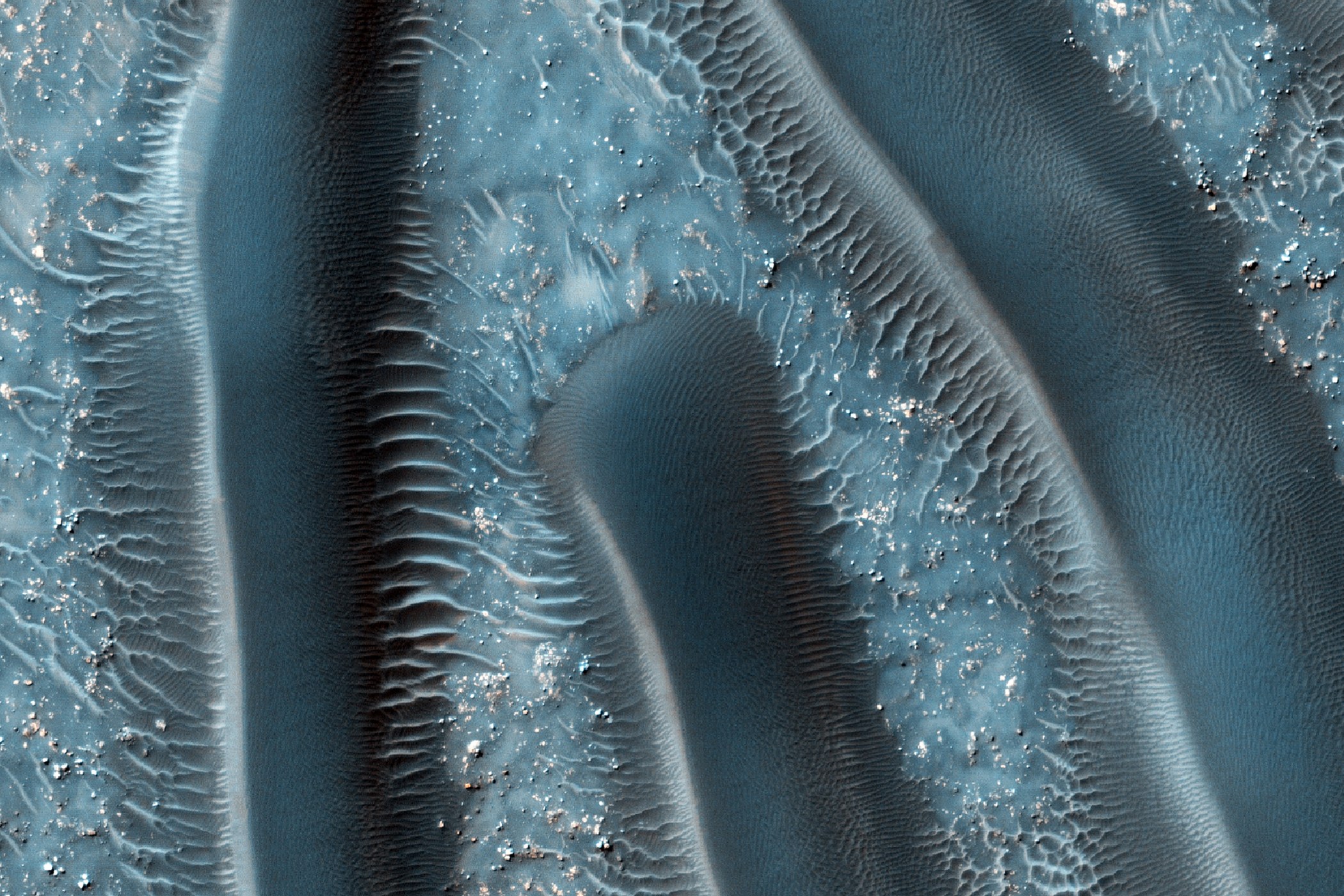Sand dunes are among the most widespread aeolian features present on Mars. Their spatial distribution and morphology are sensitive to subtle shifts in wind circulation patterns and wind strengths. These provide clues to the sedimentary history of the surrounding terrain.