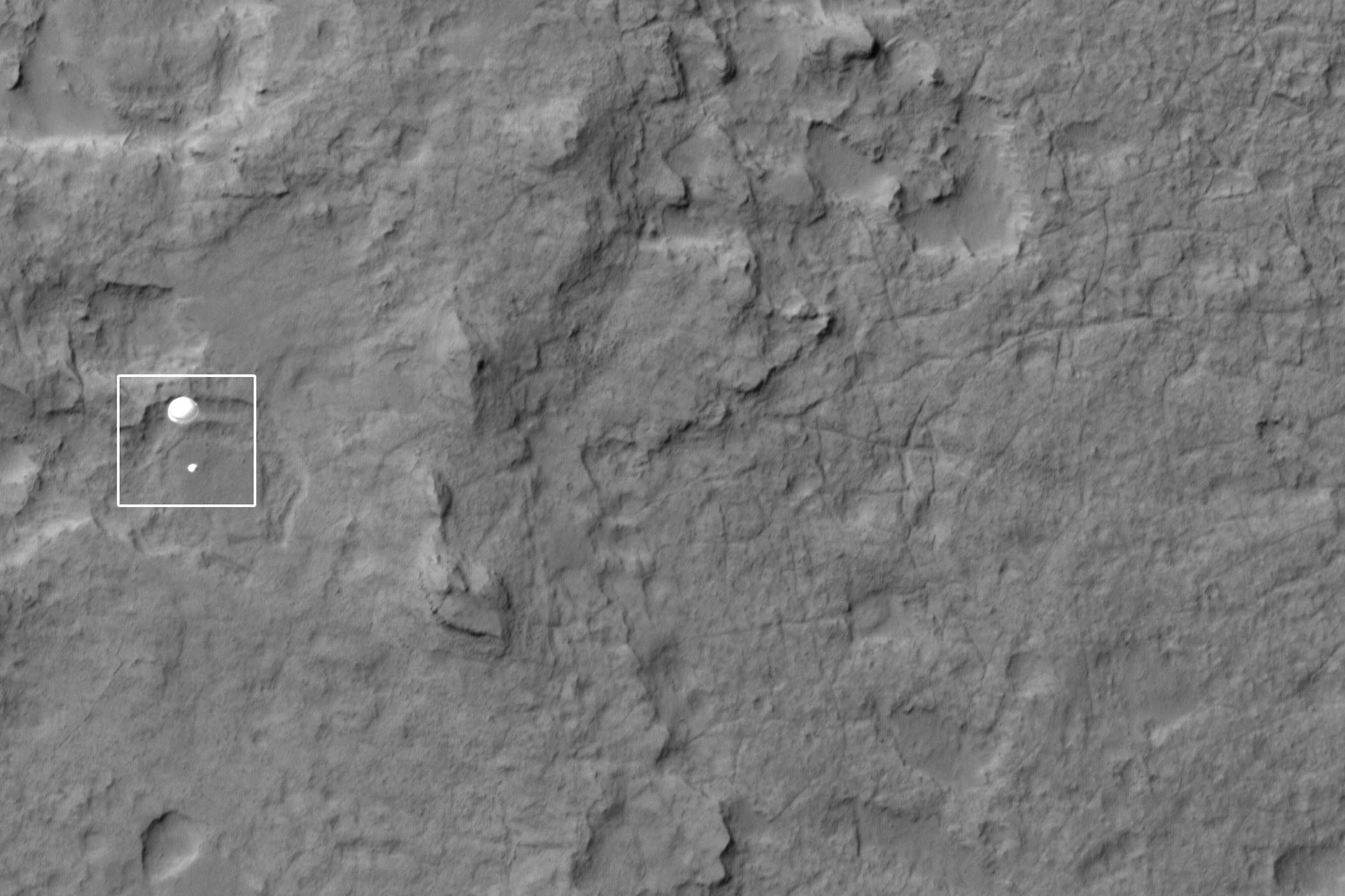 NASA's Curiosity rover and its parachute are seen by NASA's Mars Reconnaissance Orbiter as Curiosity descends to the surface around 10:32 p.m. PDT, Aug. 5, or 1:32 a.m. EDT, Aug. 6, 2012. The rover is equipped with a nuclear-powered lab capable of vaporizing rocks and ingesting soil, measuring habitability, and whether Mars ever had an environment able to support life.
