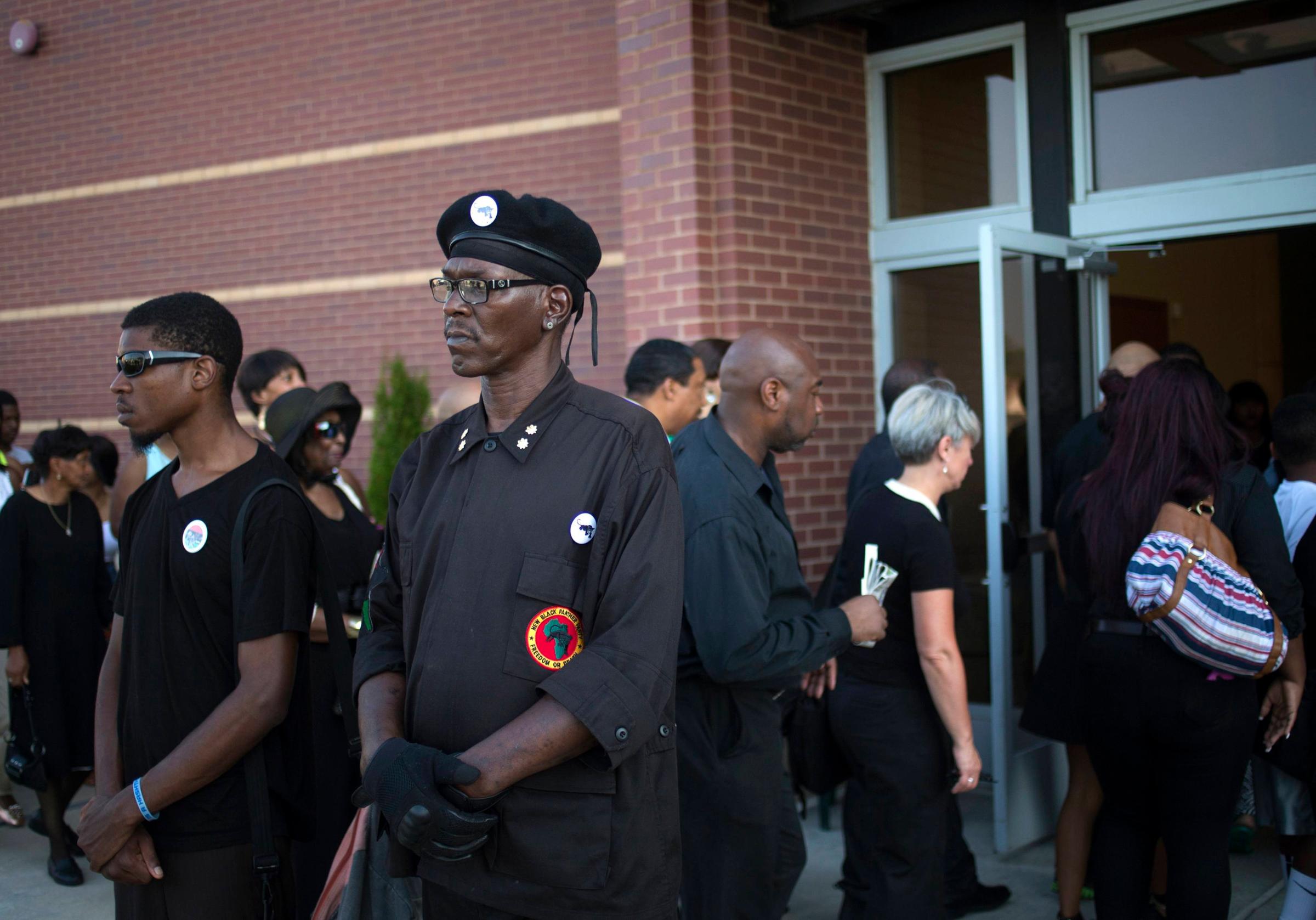 Members of the New Black Panther Party for Self-Defense (NBPP) stand guard in front of Friendly Temple Missionary Baptist Church ahead of  funeral services for 18-year-old Michael Brown in St. Louis, Missouri