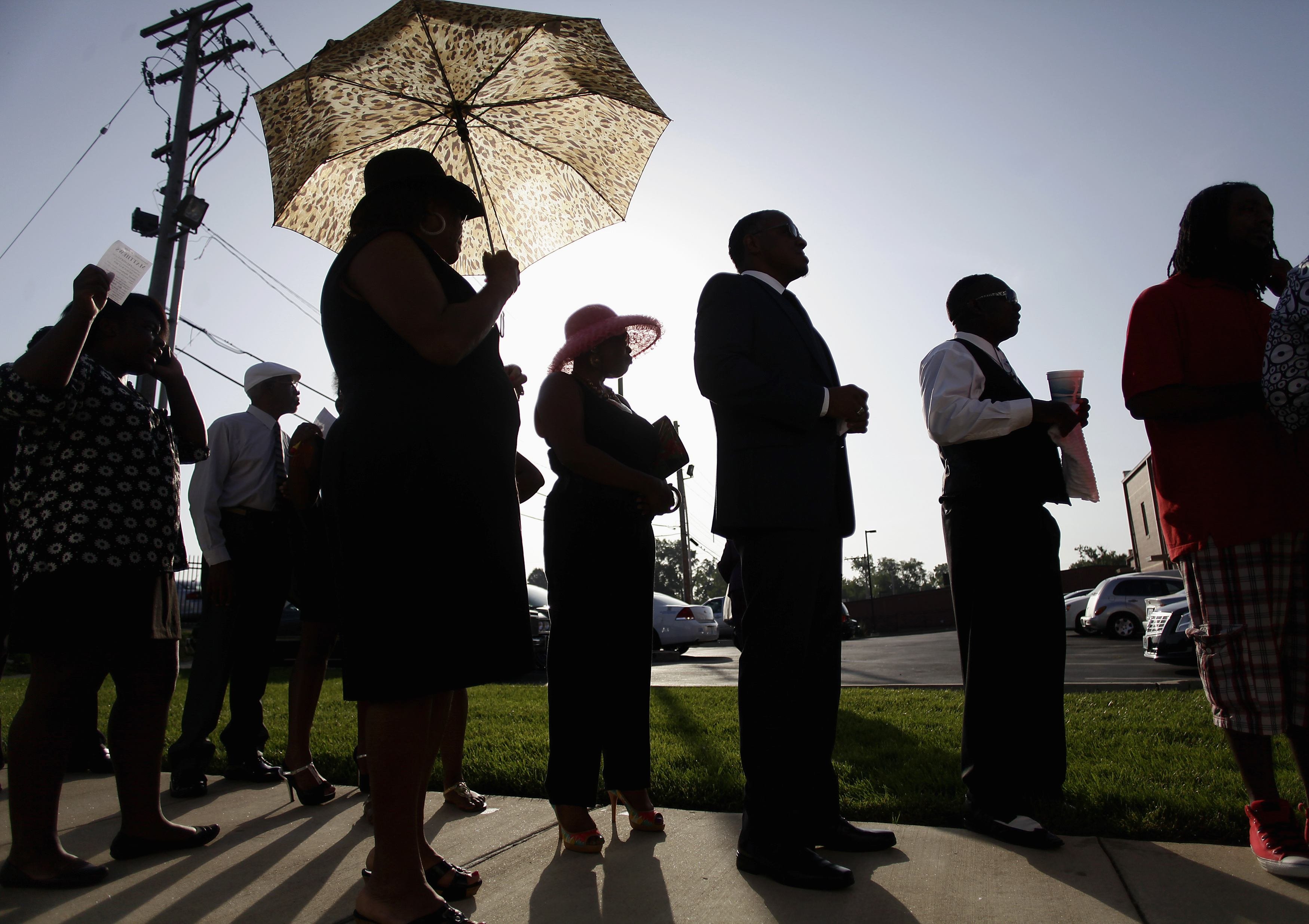 People wait in line to attend the funeral for Michael Brown at Friendly Temple Missionary Baptist Church in St. Louis on Aug. 25, 2014.