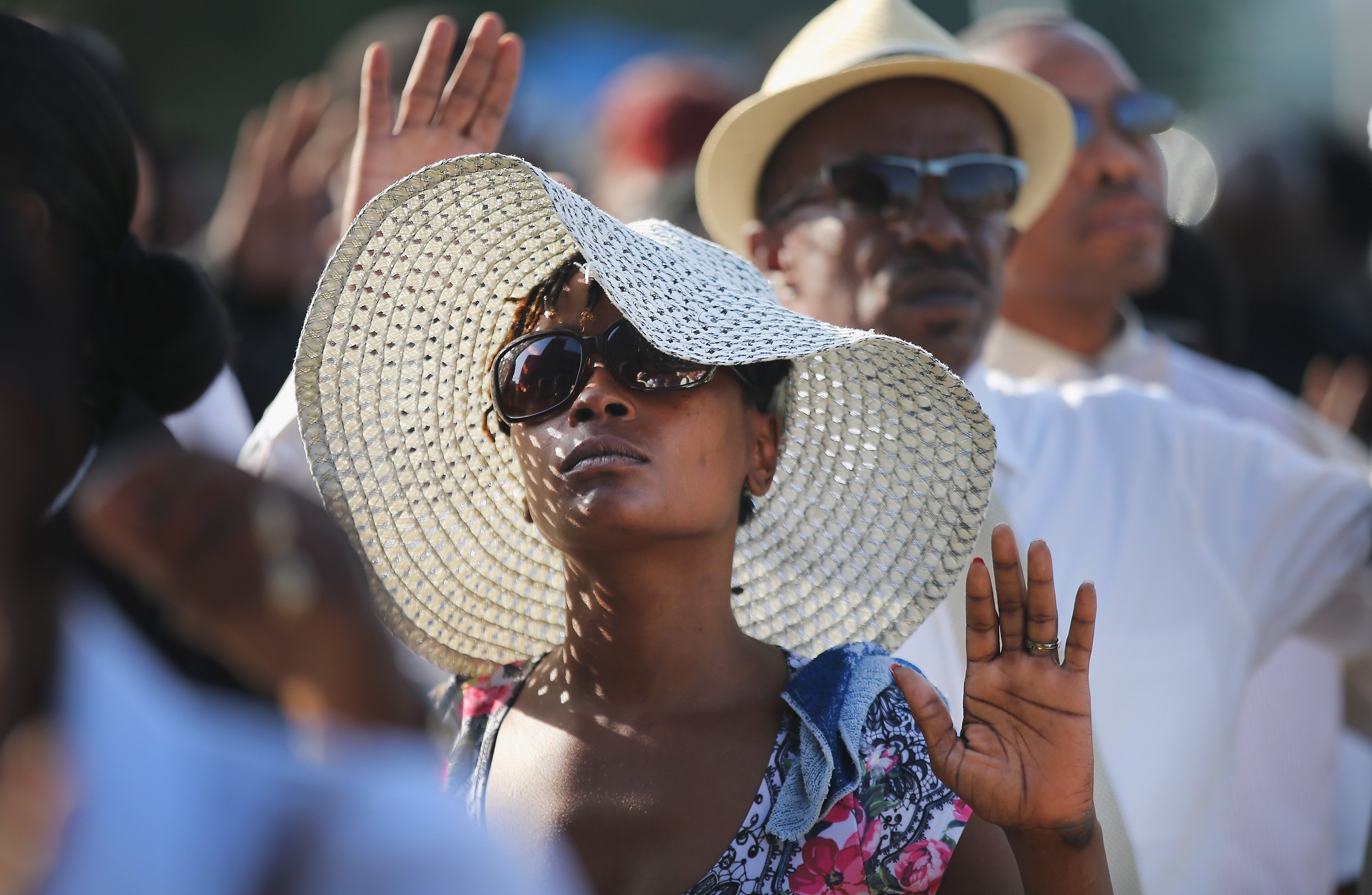 Guests raise their hands as they wait in line to enter the funeral of Michael Brown at the Friendly Temple Missionary Baptist Church in St. Louis on Aug. 25, 2014. (Scott Olson—Getty Images)