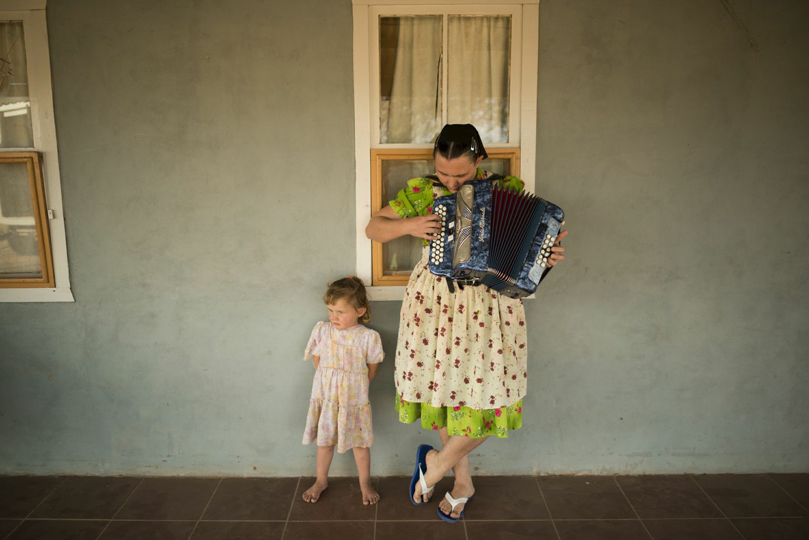 Margarita Wall is seen playing the accordion next to her daughter in Colonia Sommerfeld, Bolivia.