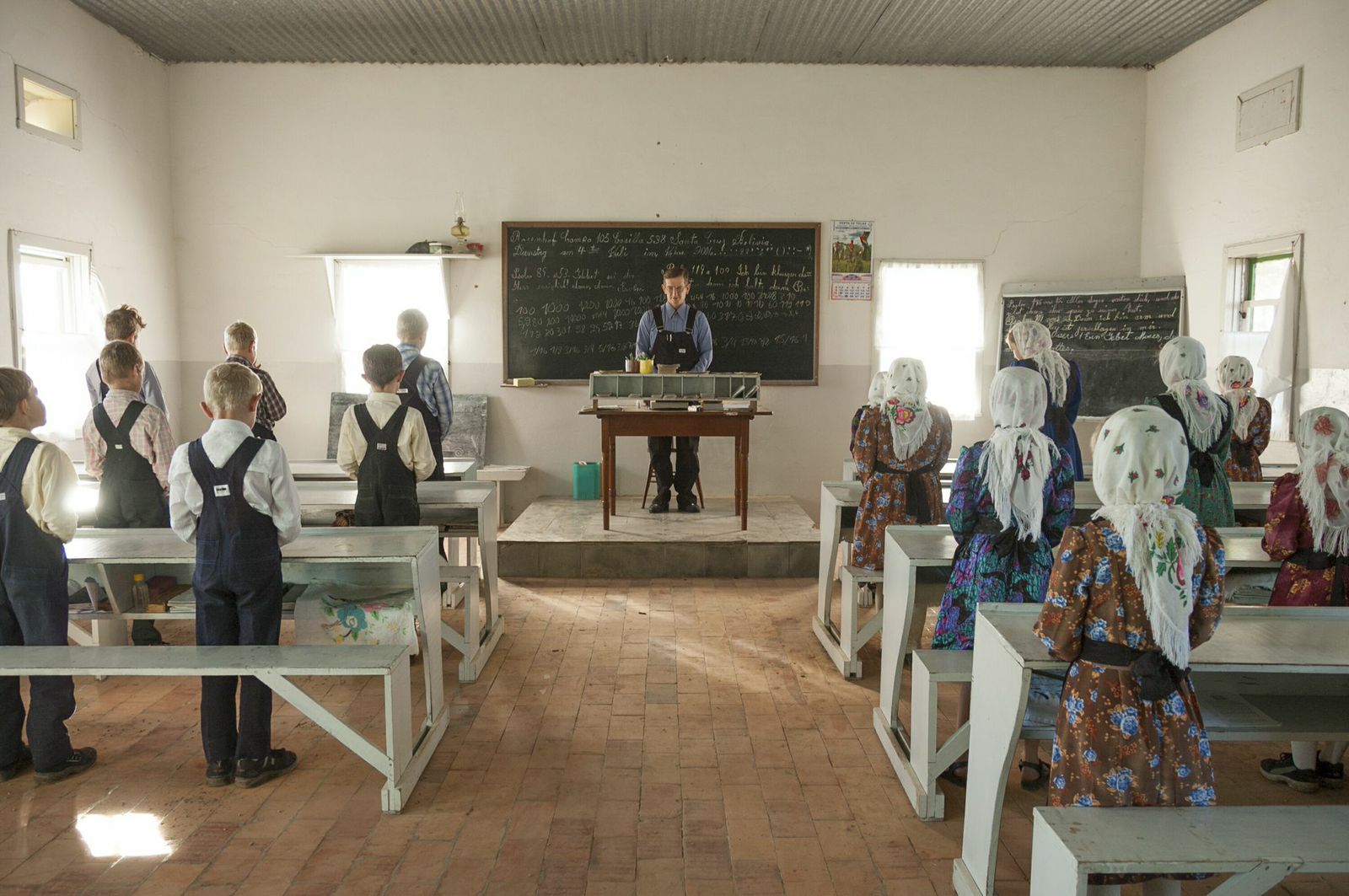 A prayer starts the classes in the professor Franz Petters's school. Girls and
                              boys seat at opposite sides of the classroom.