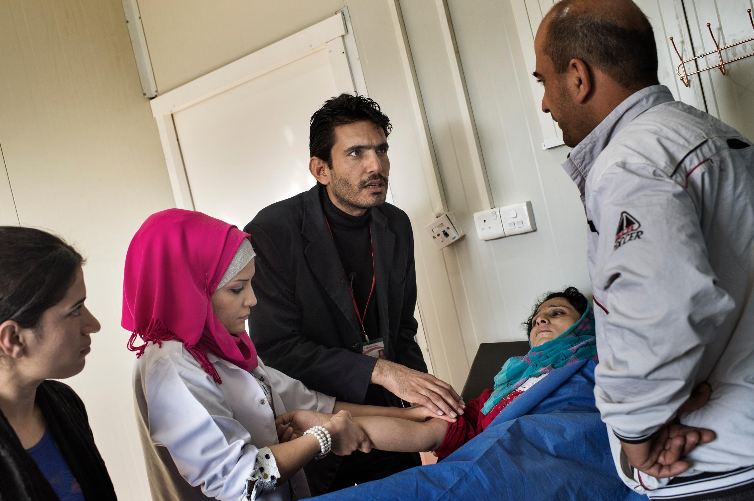 Dr. Mustapha Khalil, medical coordinator at the MSF health clinic in the Domiz refugee camp in northeast Iraq, tends to an ill patient, November 6, 2013. The clinic provides primary health services to the camp's approximately 60,000 refugees from Syria. Domiz Refugee Camp was established by local authorities back on in April 2012 to host the Syrian Kurds. The camp located 20 kms southeast of Dohuk city, in Iraqi Kurdistan and some 60 km from Syria/Iraq border. So far the total number of Syrian refugees in Kurdistan region is 60,151.