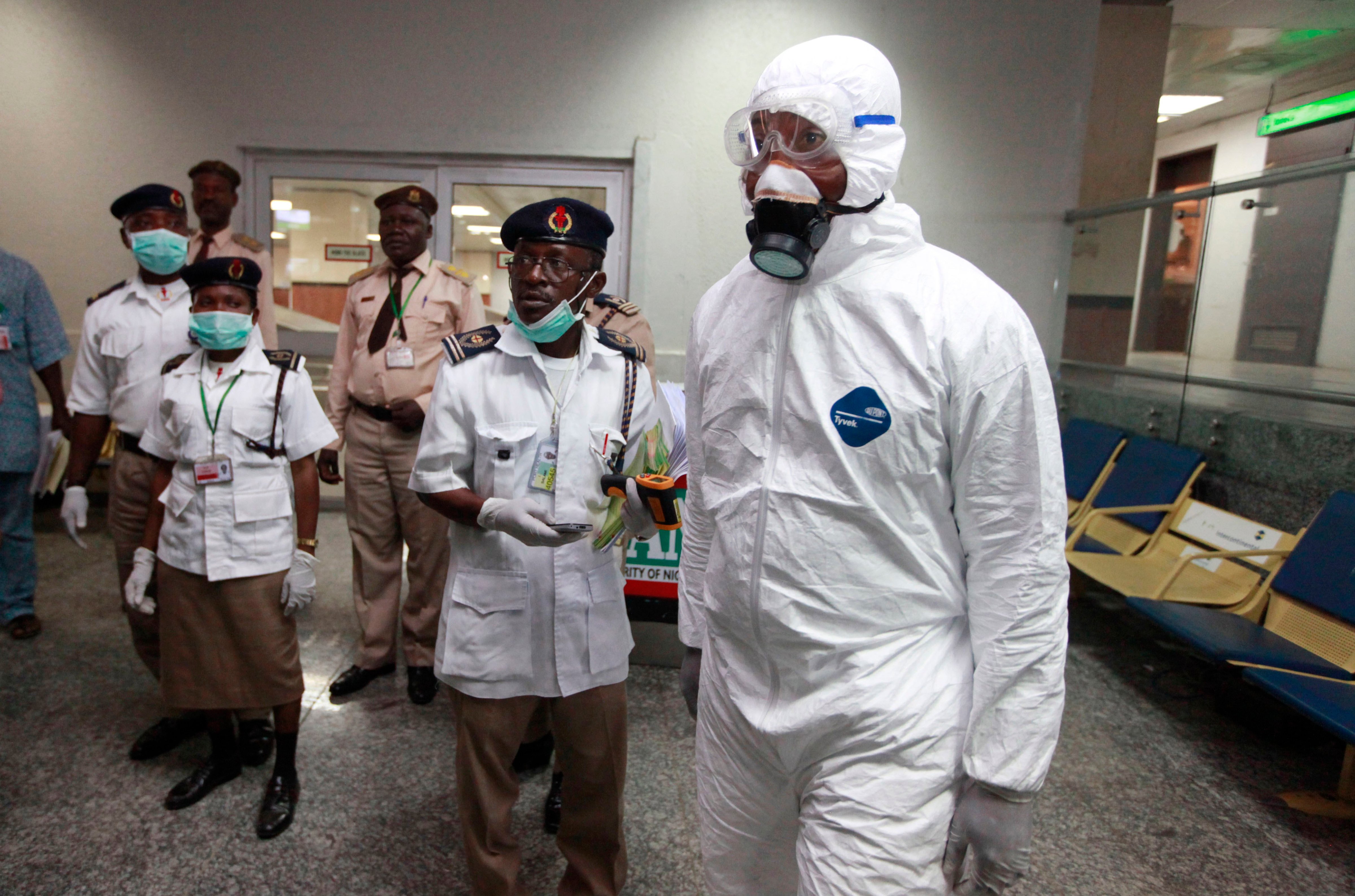 Nigerian health officials wait to screen passengers at the arrival hall of Murtala Muhammed International Airport in Lagos, Nigeria on Aug. 4, 2014. (Sunday Alamba/AP)