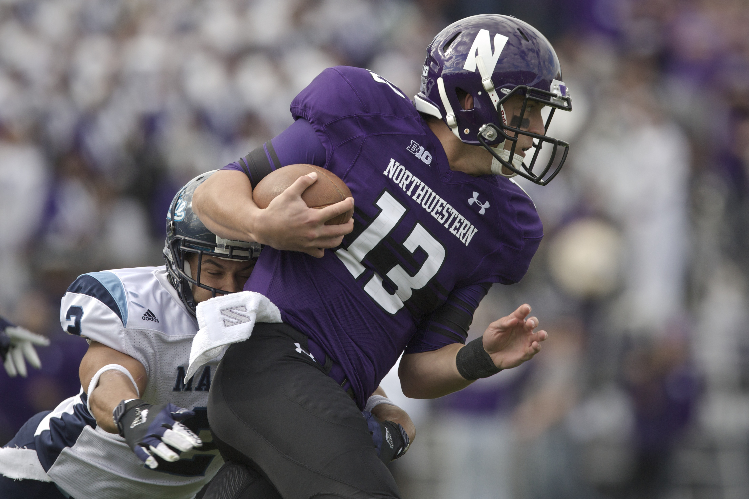 Cabrinni Goncalvesof the Maine Black Bears tackles Trevor Siemianof the Northwestern Wildcats during their college football game at Ryan Field on September 21, 2013 in Evanston, Illinois. (John Gress—Getty Images)
