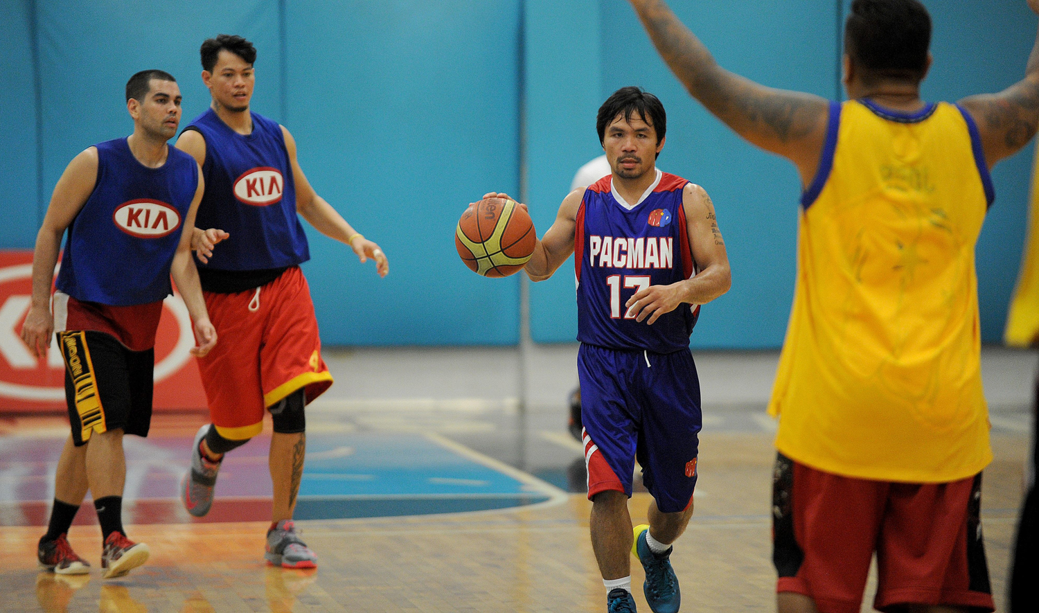 Manny Pacquiao dribbles during a practice session with the Kia Motors team in Manila on August 15, 2014. (Jay Directo — AFP/Getty Images)