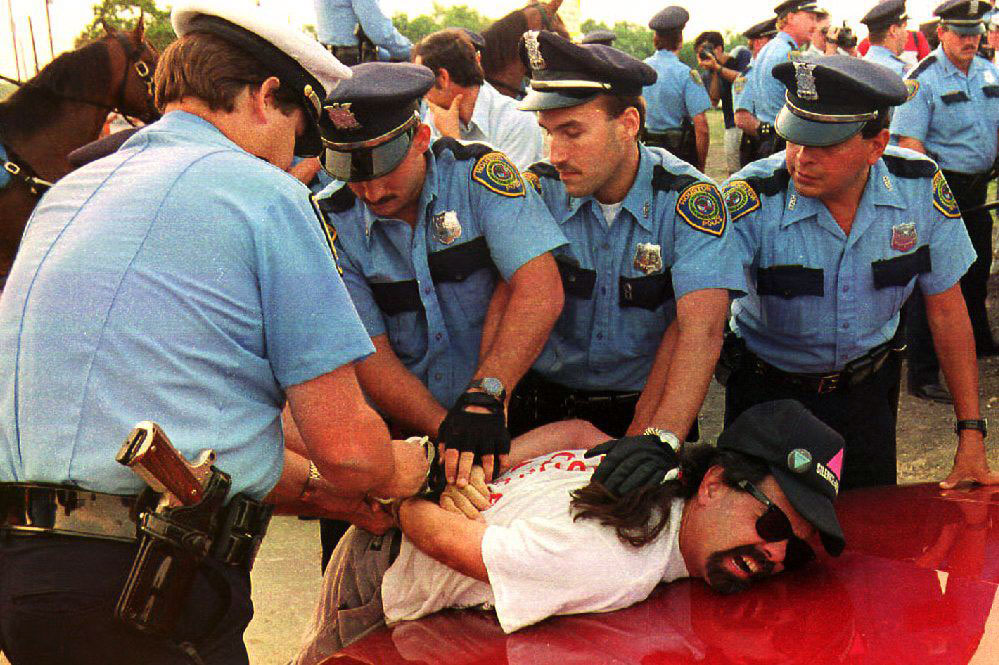 Houston police officers arrest a pro-immigration demonstrator in Houston for protesting in the wrong place, August, 1992.