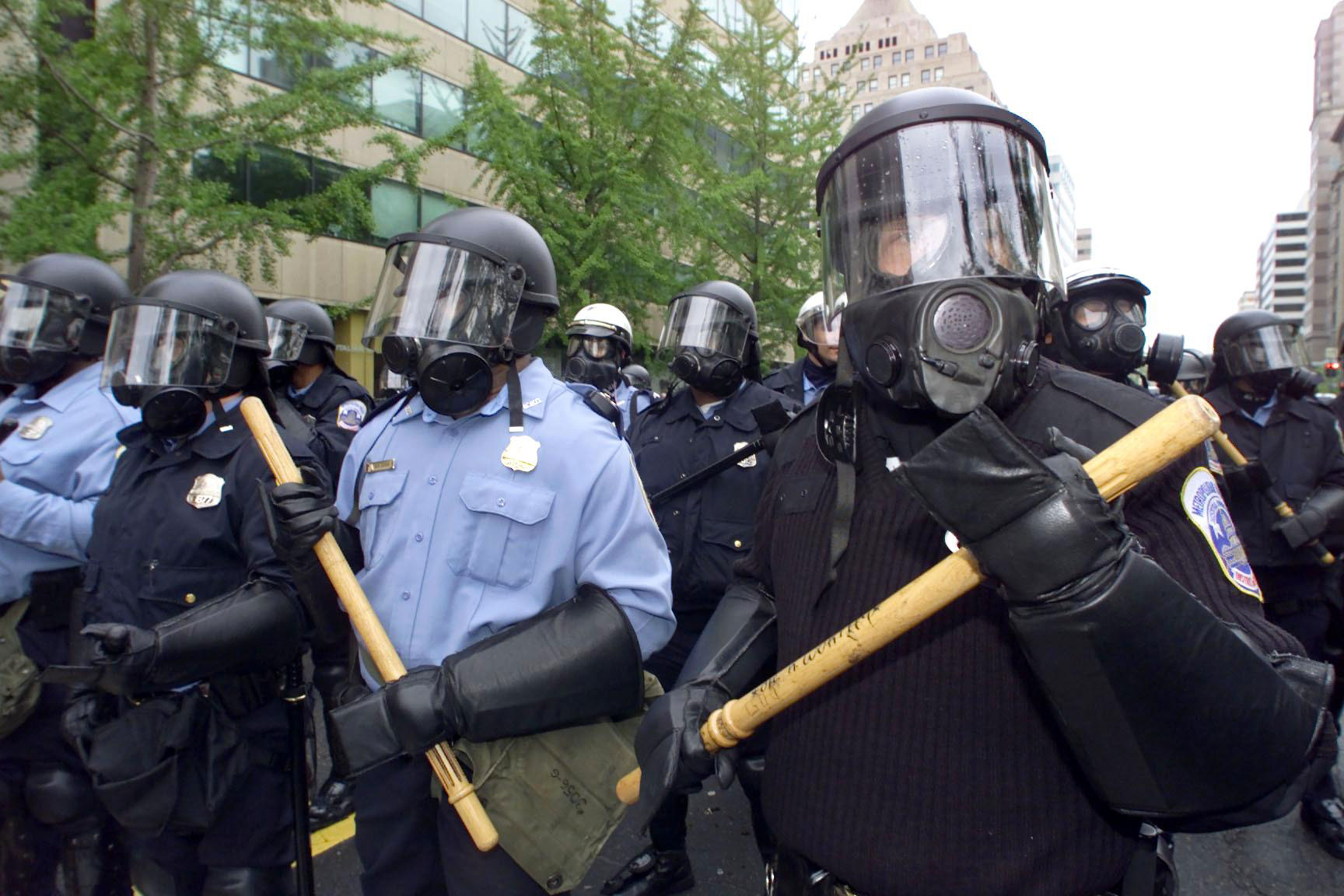 Washington police officers in riot gear stand watc