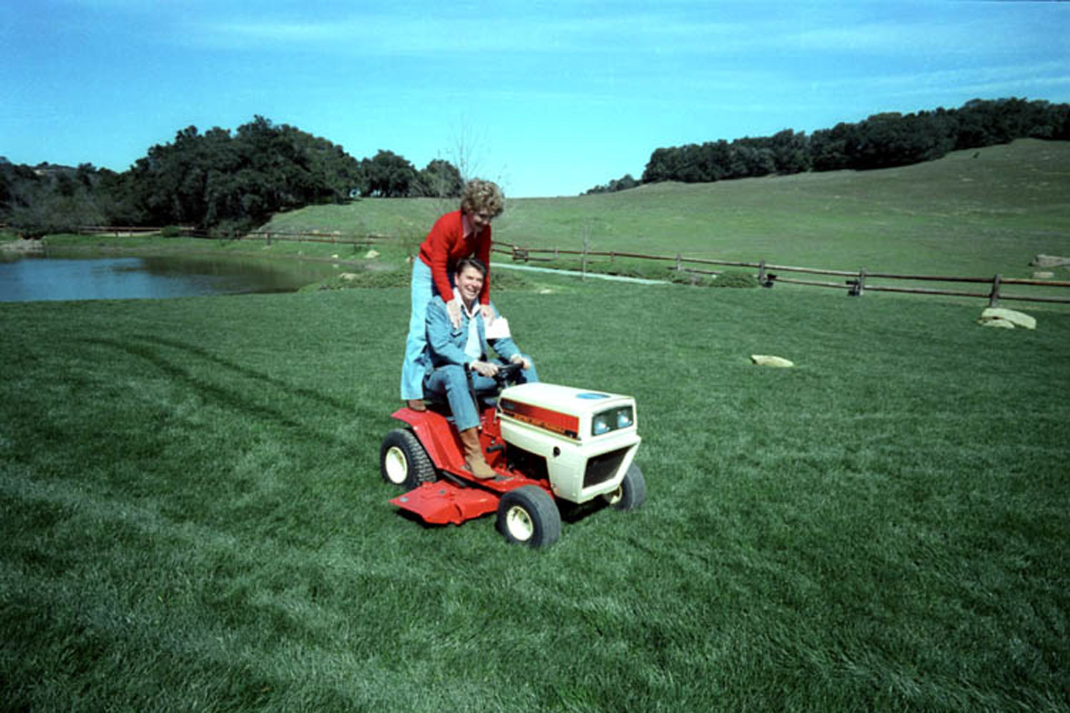 President Reagan and Nancy Reagan riding on their new lawn mower, an anniversary present, at Rancho Del Cielo. 3/4/82.
