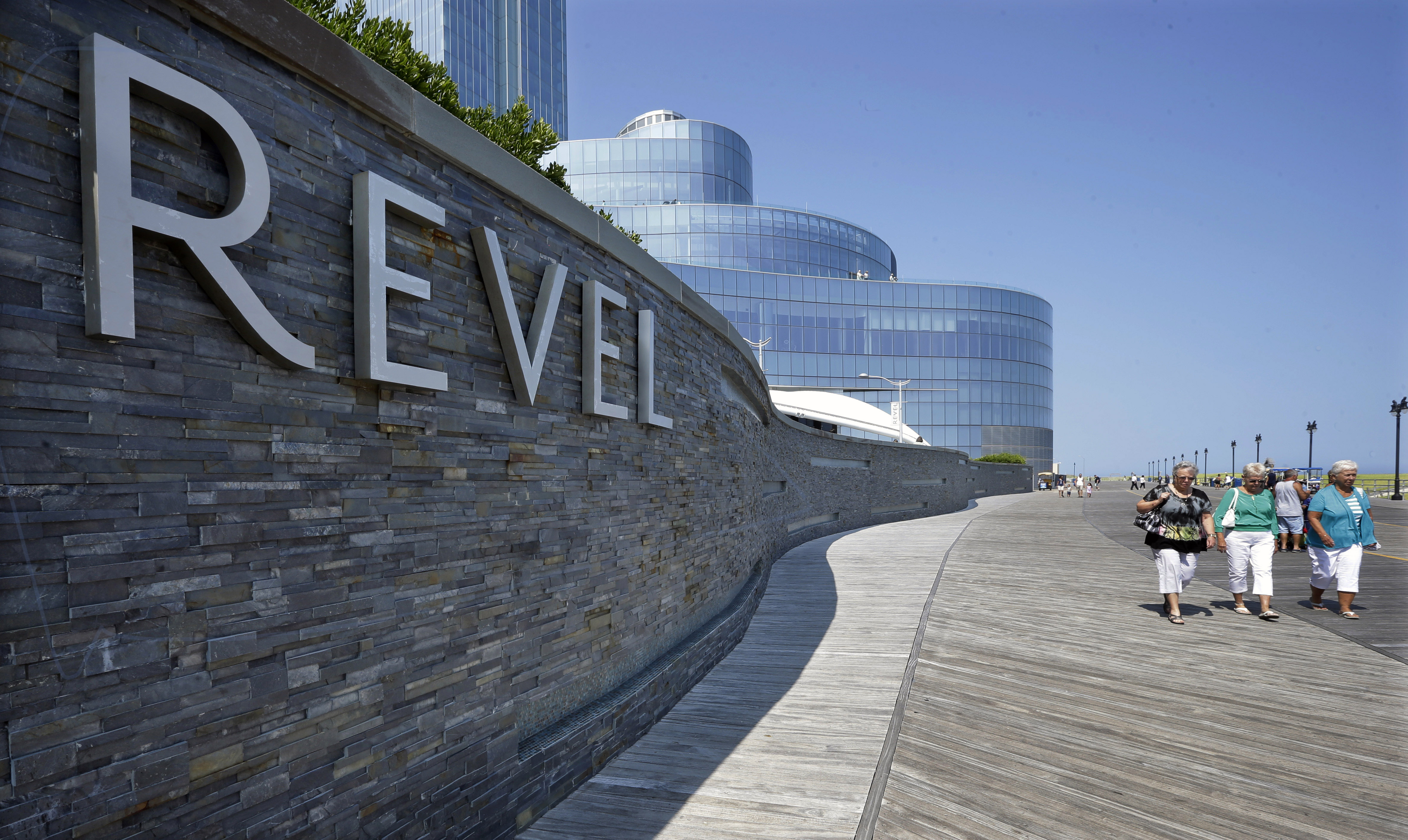 People walk past the Revel Casino Hotel in Atlantic City, N.J. on July 23, 2014. (Mel Evans—AP)