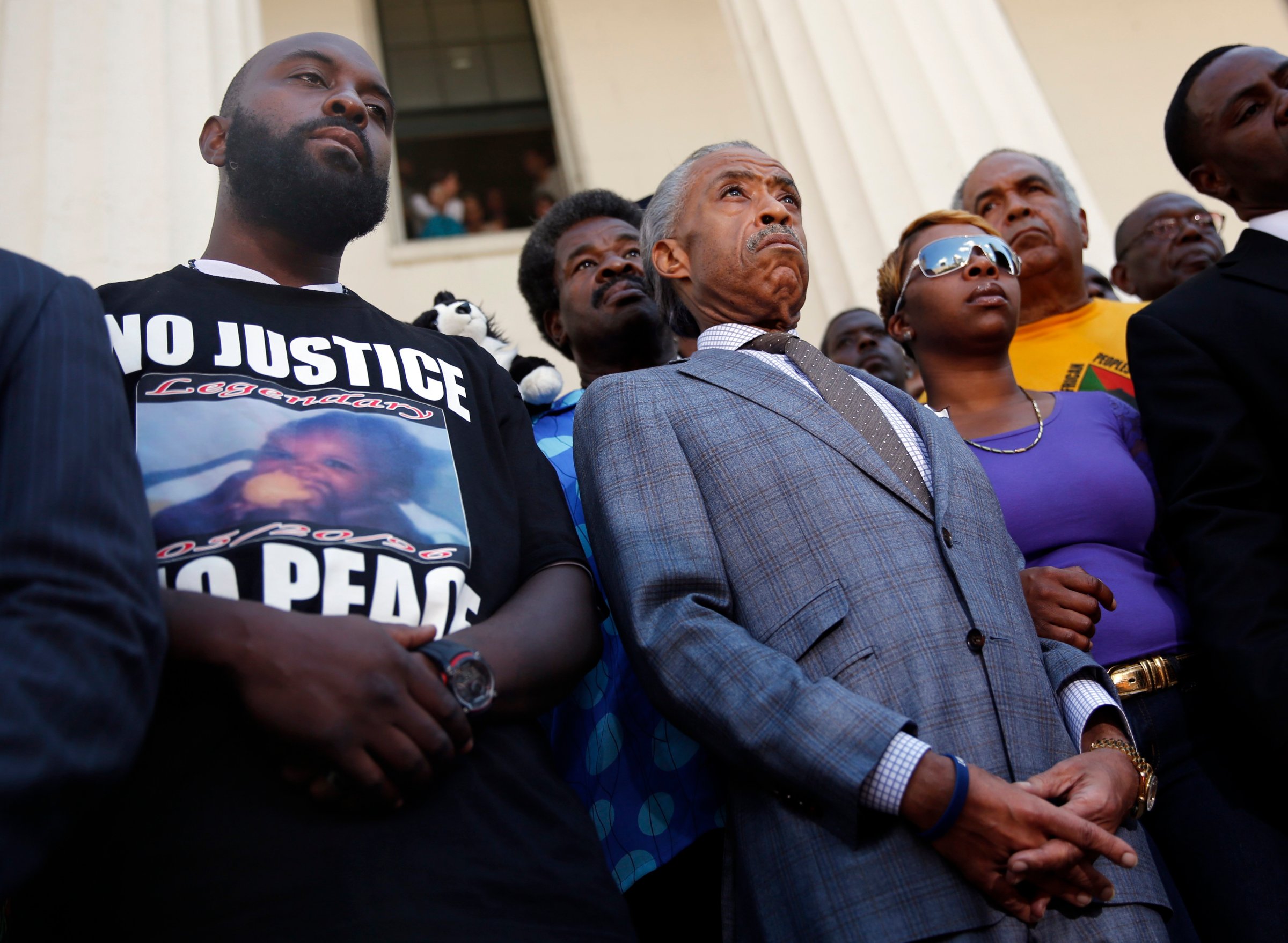 From left: Michael Brown, Sr., Reverend Al Sharpton, and Lesley McSpadden during a news conference outside the Old Courthouse in St. Louis on Aug. 12, 2014.