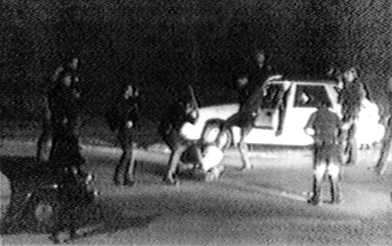 Video tape shot by George Holliday shows what appears to be a group of police officers beating Rodney King with nightsticks and kicking him as other officers look on. Los Angeles. United States. March 3, 1991.