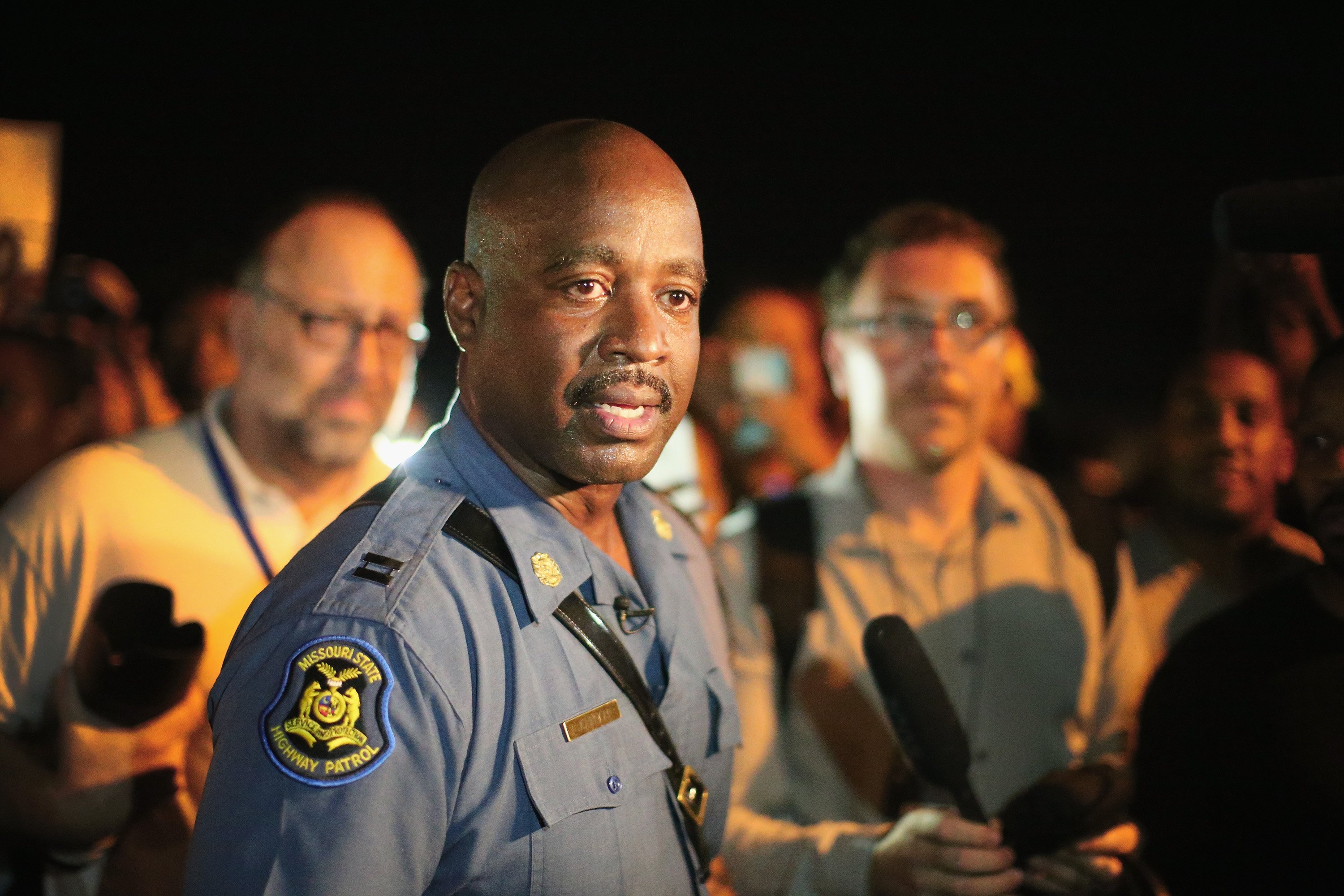 Capt. Ronald Johnson of the Missouri State Highway Patrol, who was appointed by the governor to take control of security operations in the city of Ferguson, walks among demonstrators gathered along West Florissant Avenue on August 14, 2014 in Ferguson, Missouri. (Scott Olson—Getty Images)