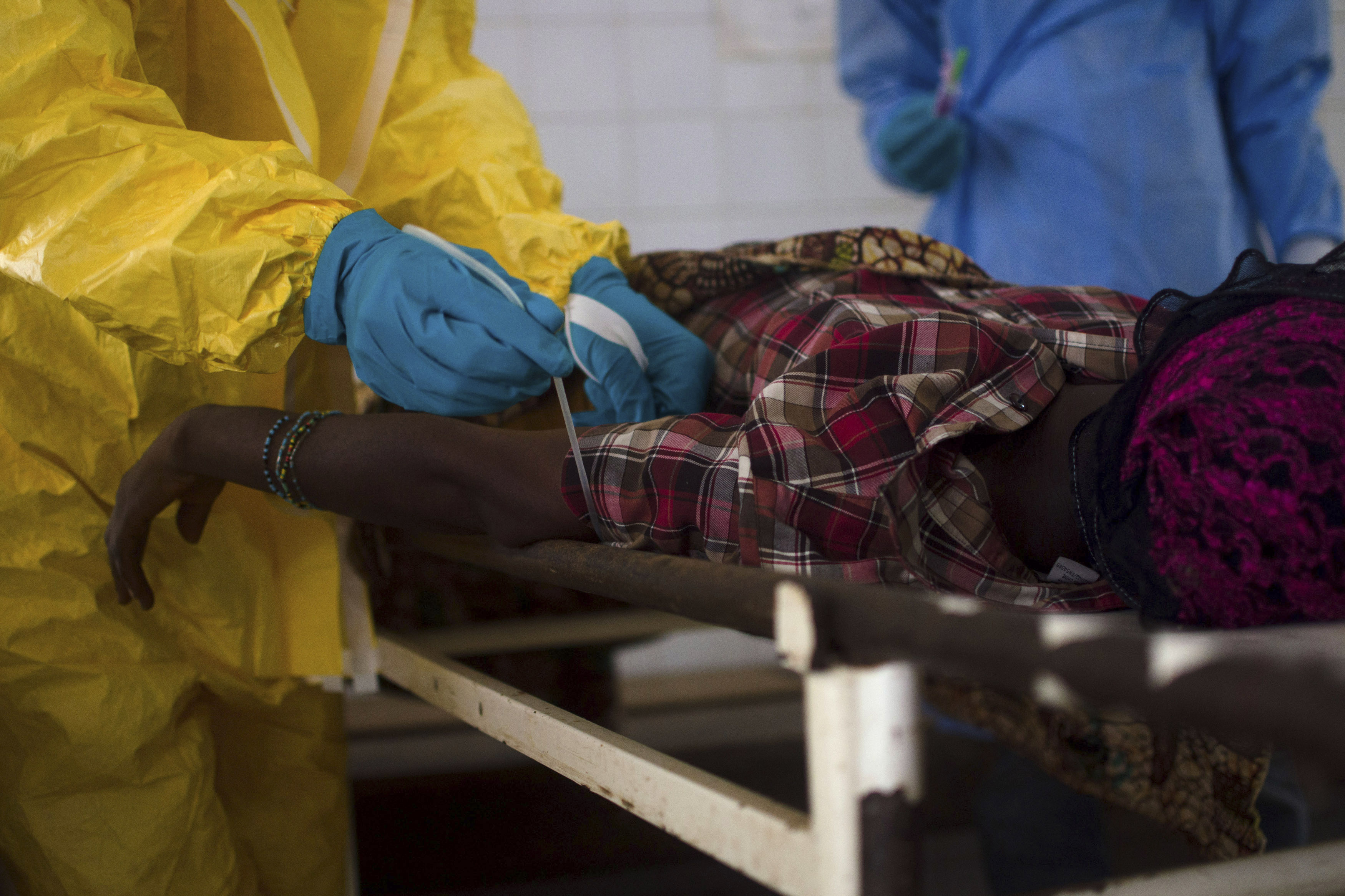 Medical staff take a blood sample from a suspected Ebola patient at the government hospital in Kenema, Sierra Leone, on July 10, 2014 (Tommy Trenchard—Reuters)