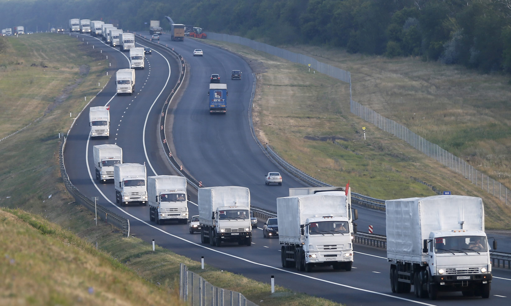 A Russian convoy carrying humanitarian aid for residents in rebel eastern Ukrainian regions moves along a road about 30 miles from Voronezh, Russia, Aug. 14, 2014. (Yuri Kochetko—EPA)