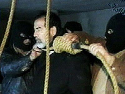 This video image released by Iraqi state television shows Saddam Hussein's guards wearing ski masks and placing a noose around the deposed leader's neck moments before his execution. Iraq. Dec. 30, 2006.