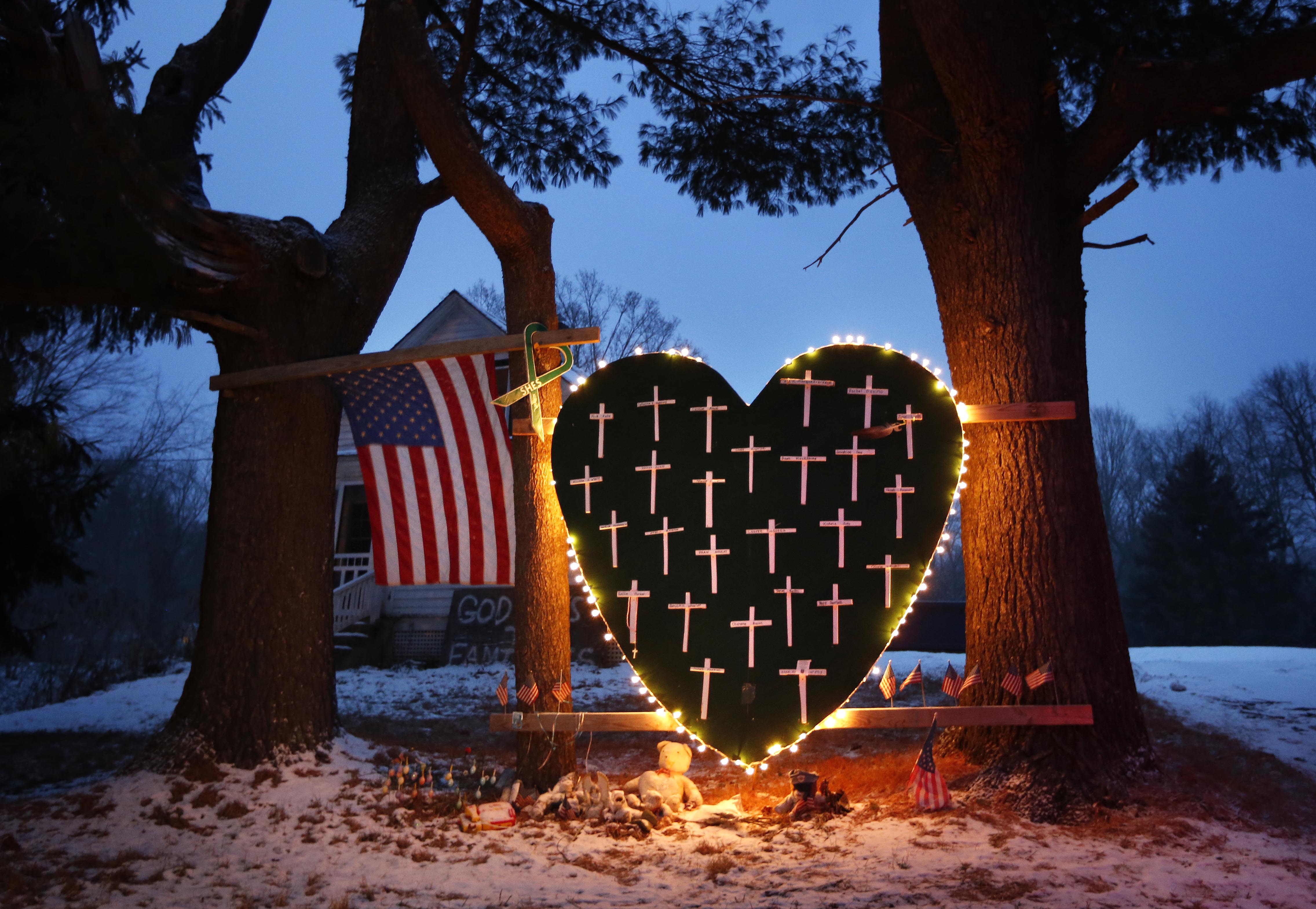 A makeshift memorial with crosses for the victims of the Sandy Hook massacre stands outside a home in Newtown, Conn., on Dec. 14, 2013, the one-year anniversary of the shootings.