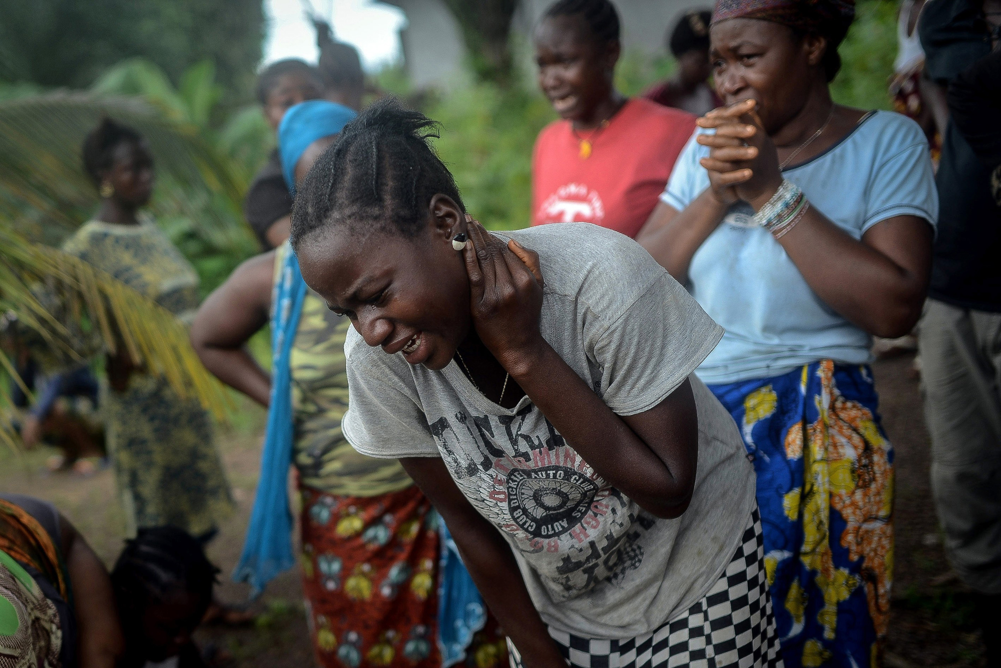 Relatives of an Ebola victim mourn in Lango village, Kenema, Sierra Leone on Aug. 25, 2014.