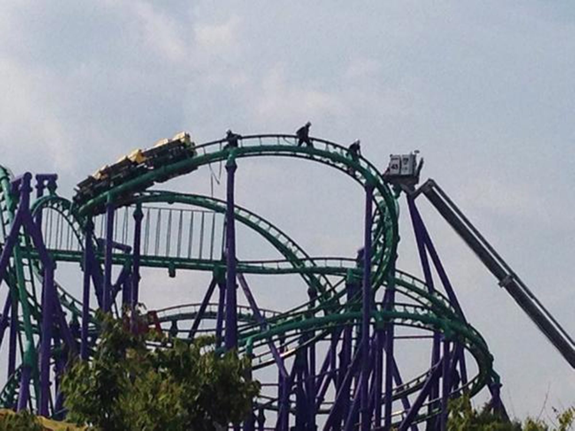 Firefighters rescuing 24 riders stuck atop the Joker's Jinx roller coaster at Six Flags   theme park in Prince George's County, Maryland on August 10, 2014.