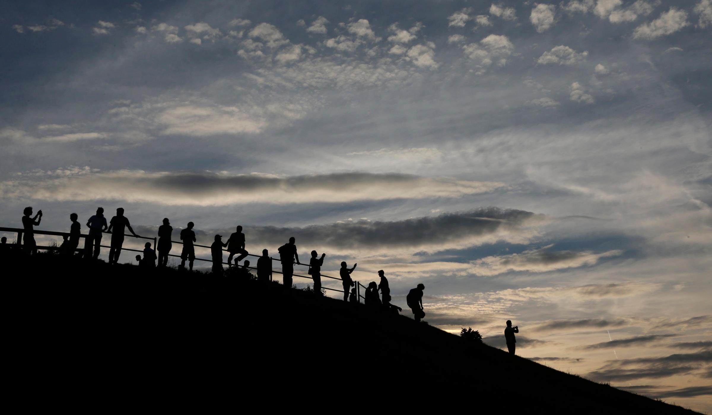 People wait for the upcoming Super Moon in the Olympic Park in Munich, Germany on August 10, 2014.