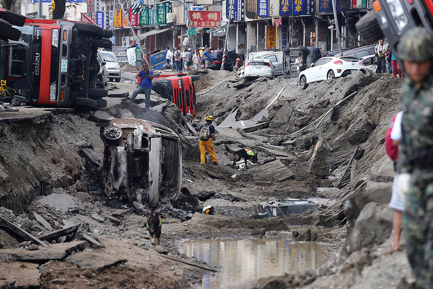 Rescue personnel survey the wreckage after an explosion in Kaohsiung, southern Taiwan on Aug. 1, 2014.