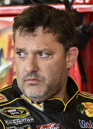 Tony Stewart stands in the garage area after a practice session for Sunday's NASCAR Sprint Cup Series auto race at Watkins Glen International, in Watkins Glen, N.Y on August 8, 2014.