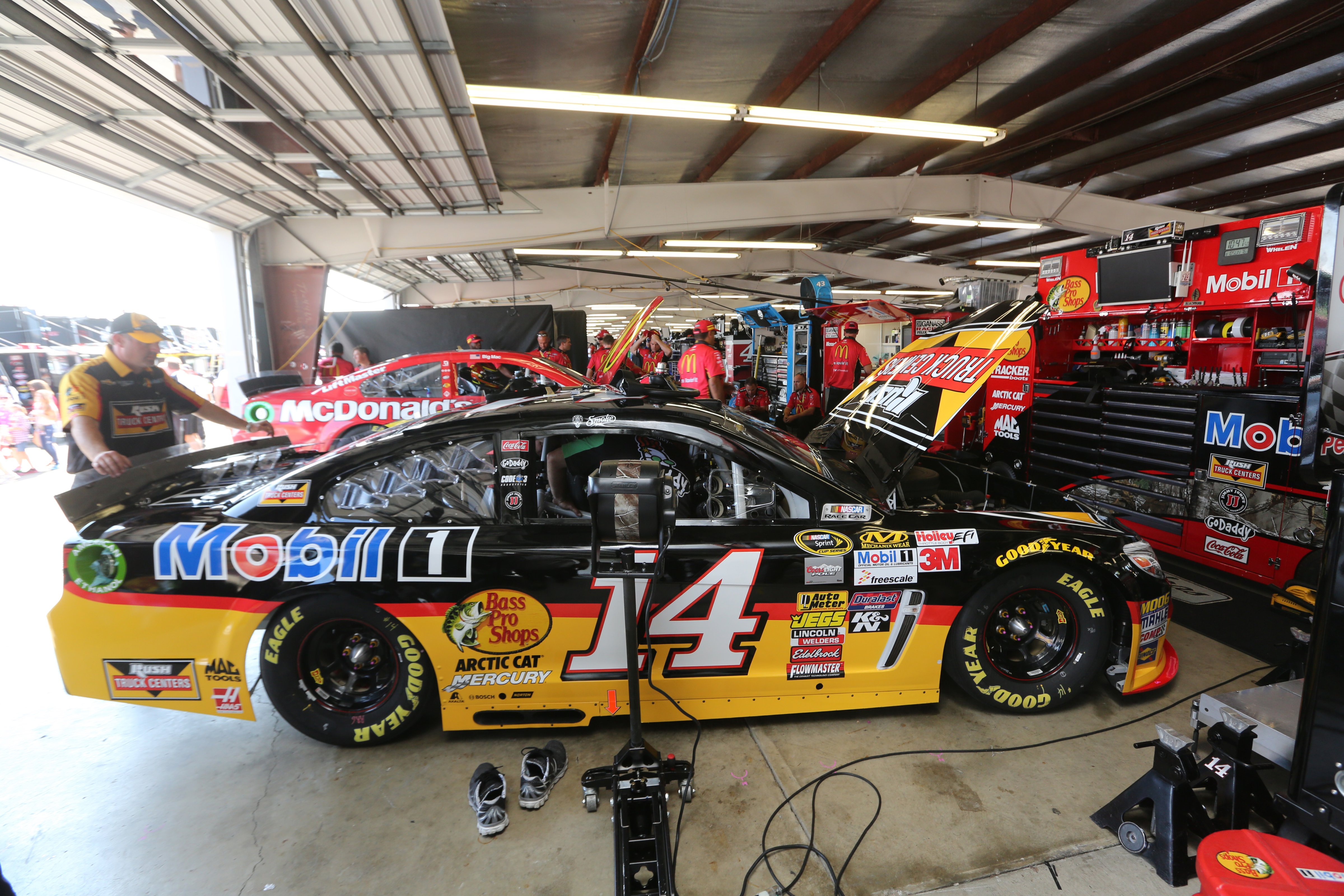 The #14 Rush Truck Centers/Mobil 1 Chevrolet is prepared by its crew in the garage area prior to the NASCAR Sprint Cup Series Cheez-It 355 at Watkins Glen International on August 10, 2014 in Watkins Glen, New York. (Jerry Markland—Getty Images)