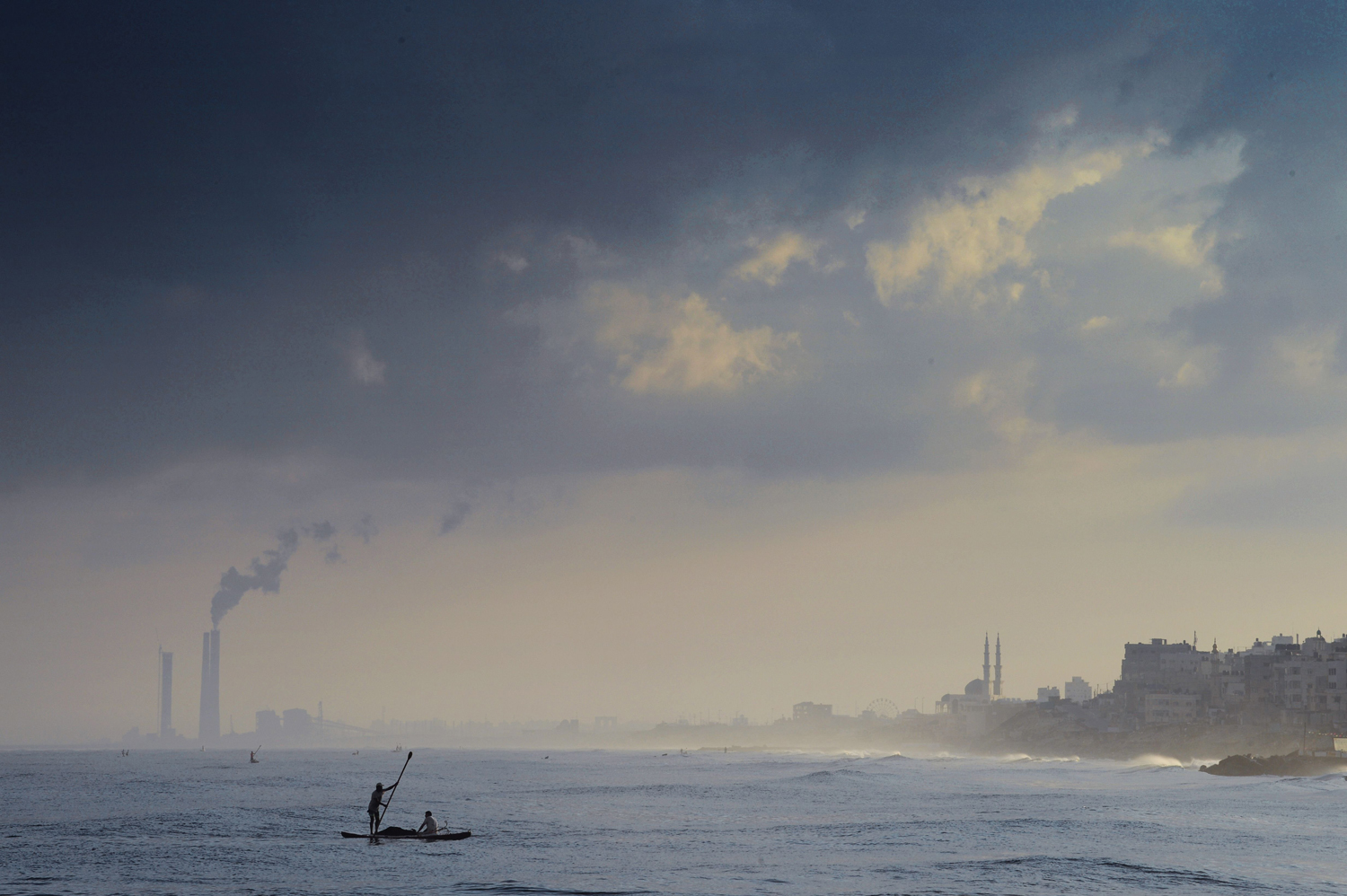 Aug. 10, 2014. 
                              Two Palestinian fishermen paddle their small boat a few hundred yards off the beach in Gaza City while casting their nets in search of small fish.