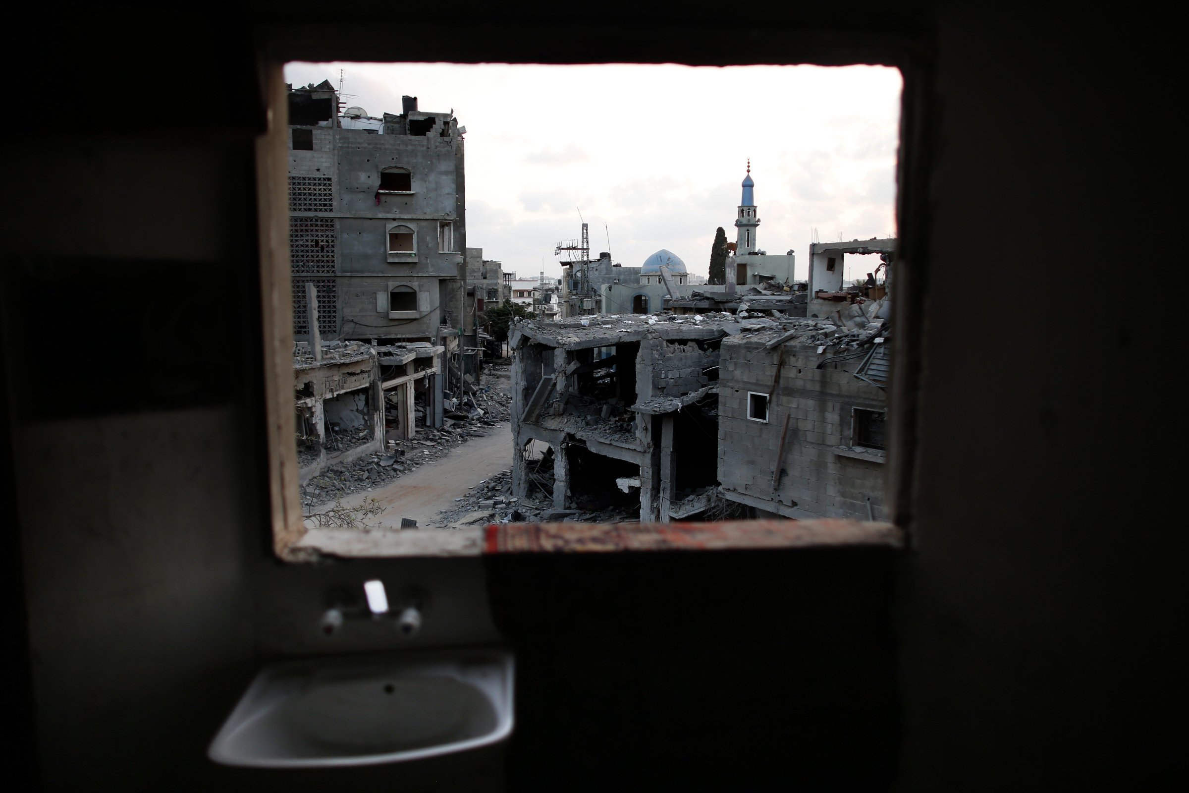 Destruction is seen from the bathroom of a Palestinian apartment in the northern Gaza Strip city of Beit Hanun, on August 18, 2014.