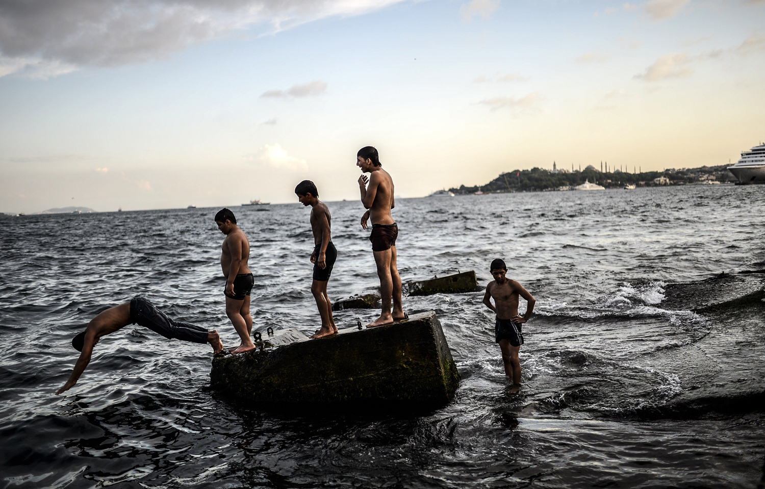 Aug. 8, 2014. Syrian refugee boys have a swim in the Bosphorus on  at Kabatas in Istanbul, Turkey.