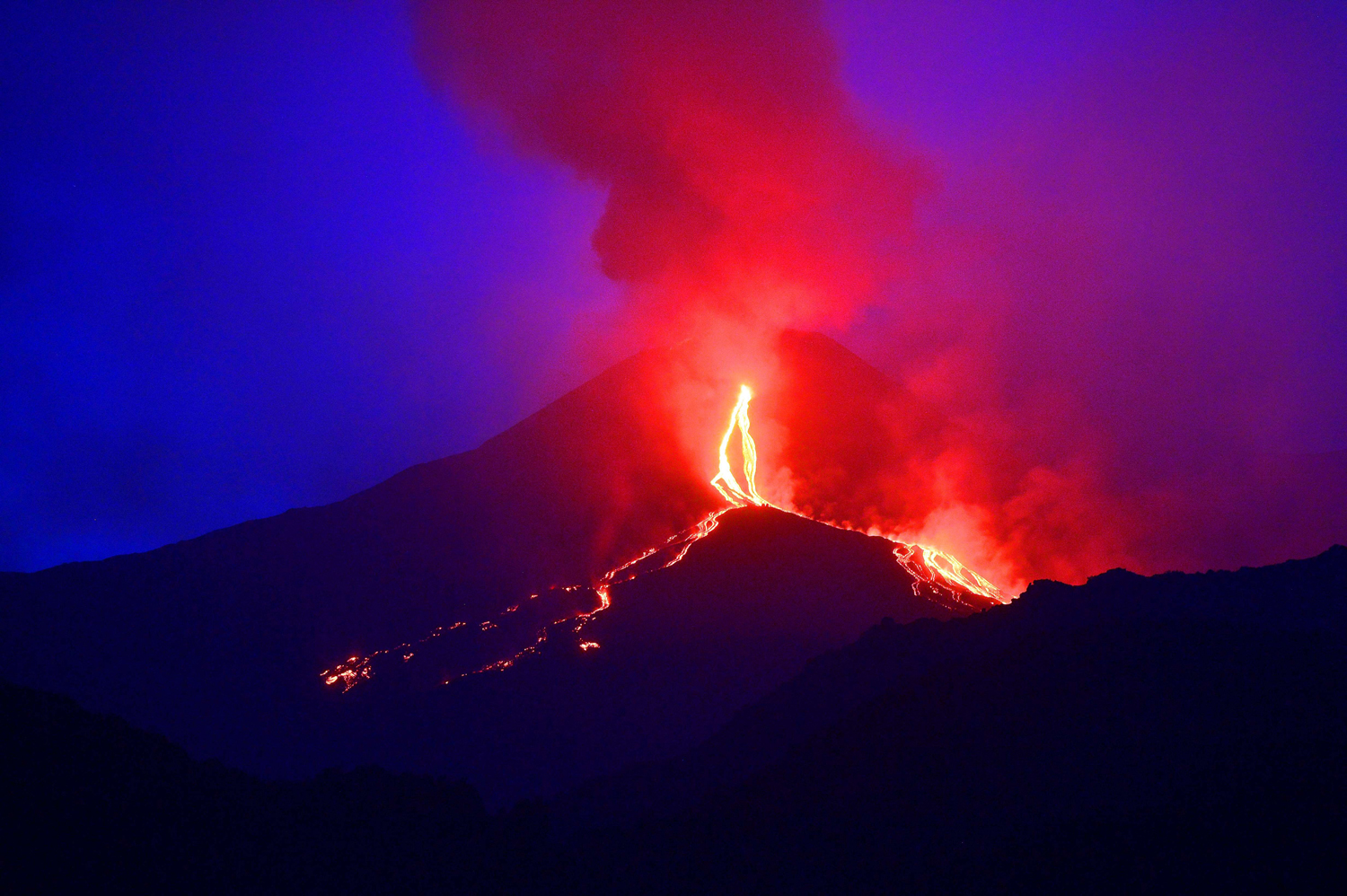 Aug. 13, 2014.
                              Lava flows from the Mount Etna volcano on the southern Italian island of Sicily near Catania.
