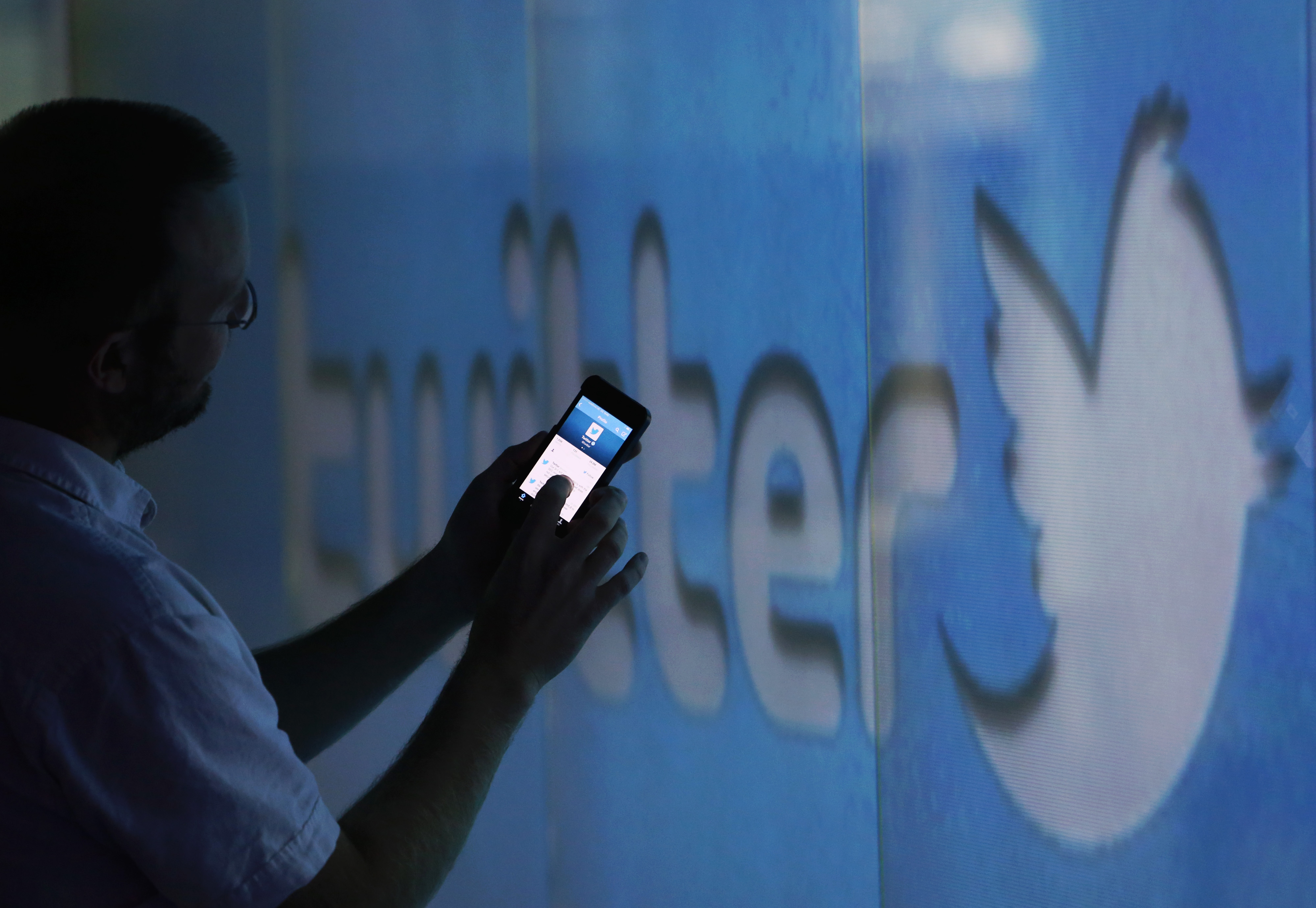 A user scrolls through a Twitter feed. (Bloomberg via Getty Images)