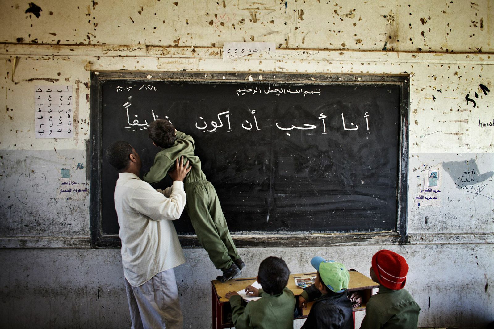 A teacher helps a student  at a public school in Sanaa, Dec. 2012. More women in Yemen are now being trained as teachers, because many parents, especially the deeply religious ones, will only allow their daughters to be taught by women.