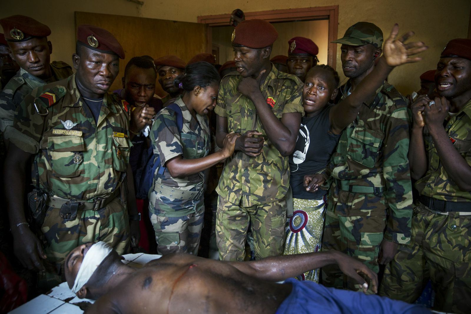 Army soldiers  mourn the death of a colleague, who was killed by members of the Seleka rebel group. Bangui, Central African Republic.
