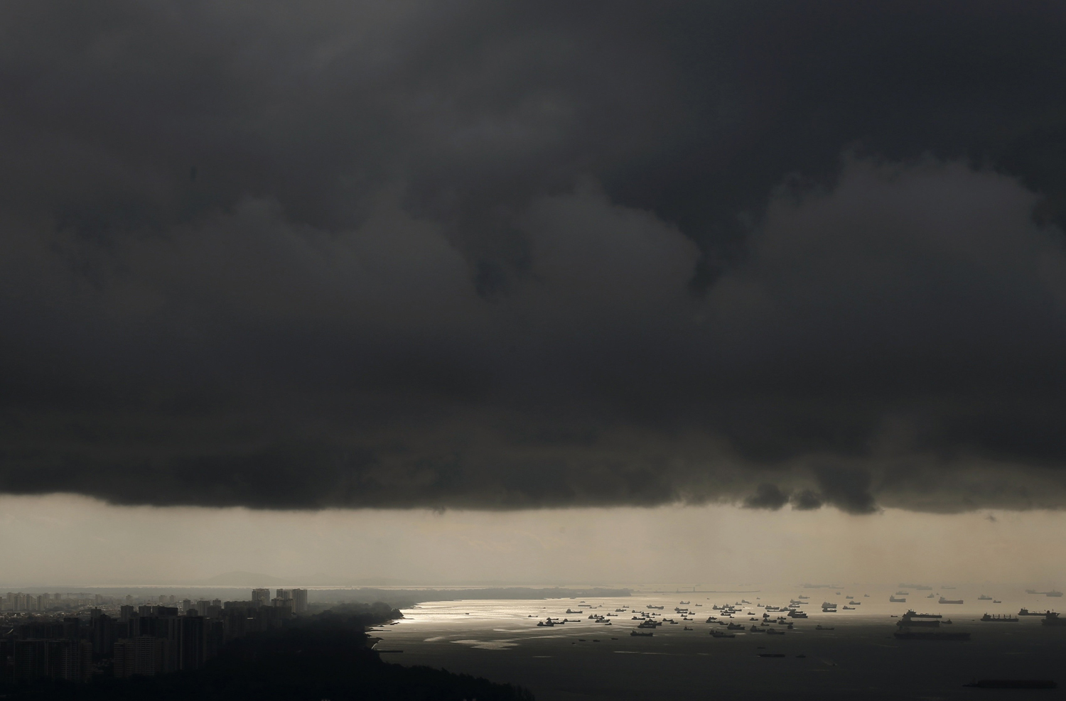 Aug. 15, 2014. Vessels anchor in the sea as storm clouds gather over the east coast of Singapore.
