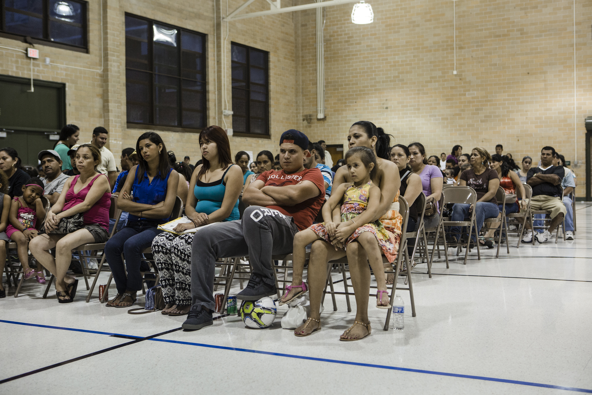 Attendees listen to speakers at the weekly meeting of "Congreso," or the Congress of Day Laborers. This is one branch of the New Orleans Workers' Center for Racial Justice, New Orleans, Aug. 6, 2014. (William Widmer for TIME)