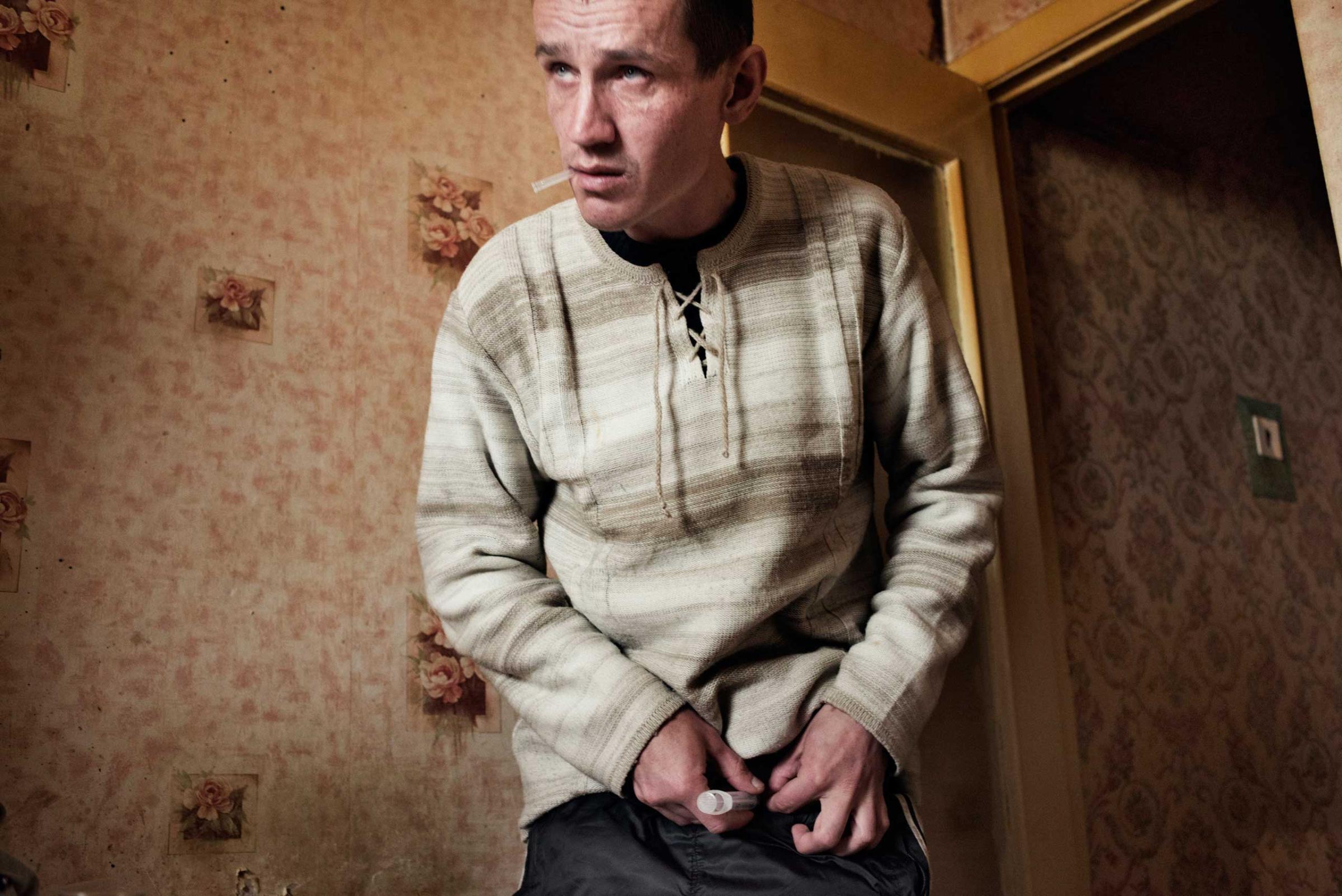 The following photographs were taken in Yekaterinburg, Russia in 2013.Alexei, age 33, injects a dose of krokodil. Because of his dependence on krokodil, Alexei has injuries and swelling around his feet and is forced to walk with a cane.