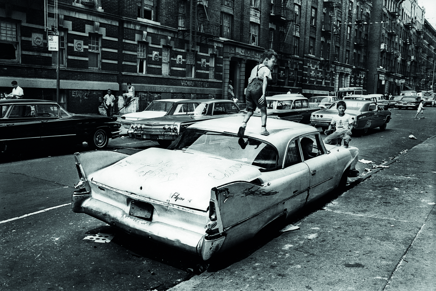 From Jean-Pierre Laffont's Photographer's Paradise, published by Glitterati
                              Bronx, New York City, NY. Summer of 1966.
                              An abandoned car becomes a place for kids to play in Fox Street.
                              From the mid-1960s to the late-1970s, quality of life for Bronx residents declined sharply.