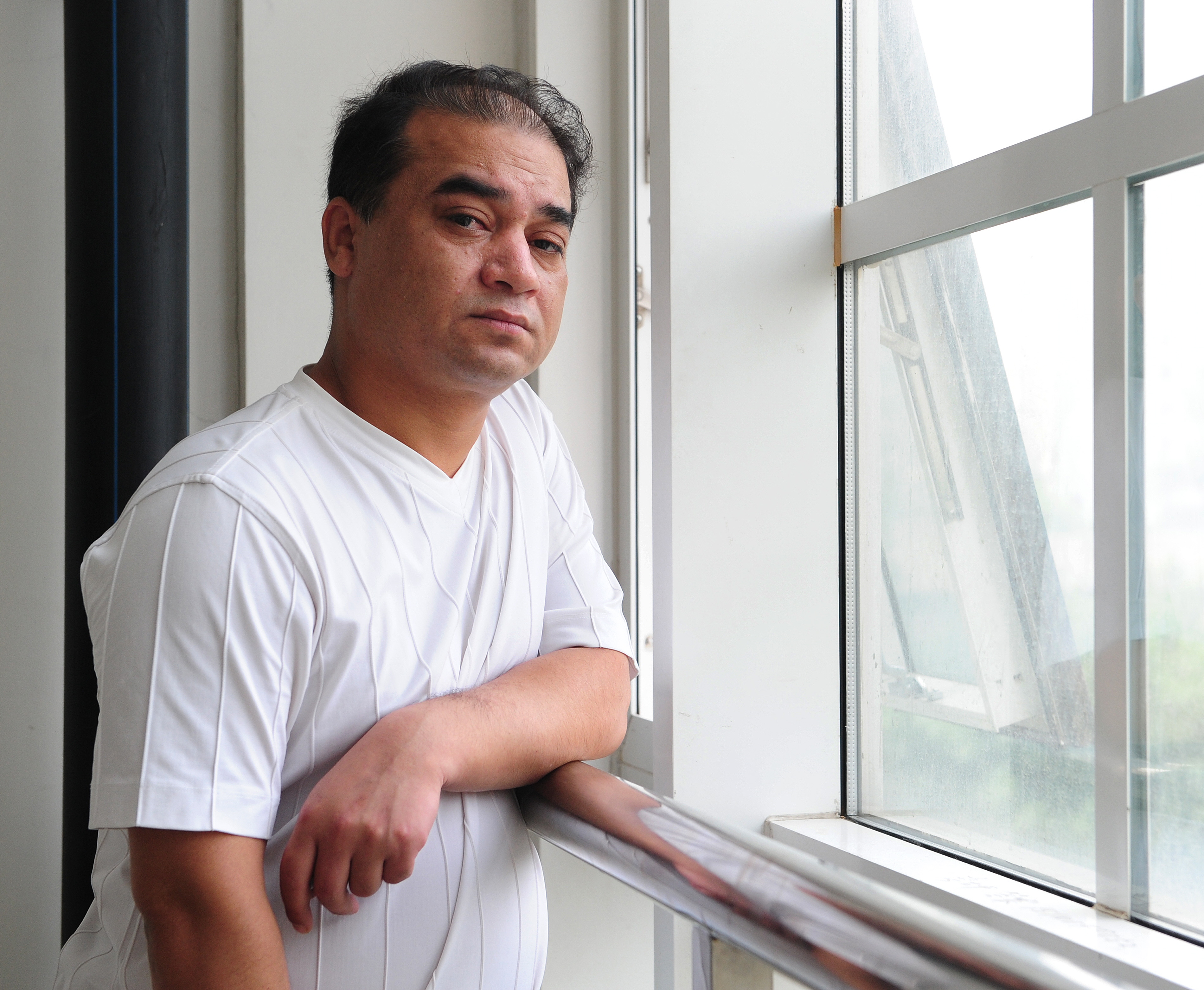 University professor, blogger, and member of the Muslim Uighur minority, Ilham Tohti  pauses before a classroom lecture in Beijing on June 12, 2010. (Frederic J. Brown—AFP/Getty)
