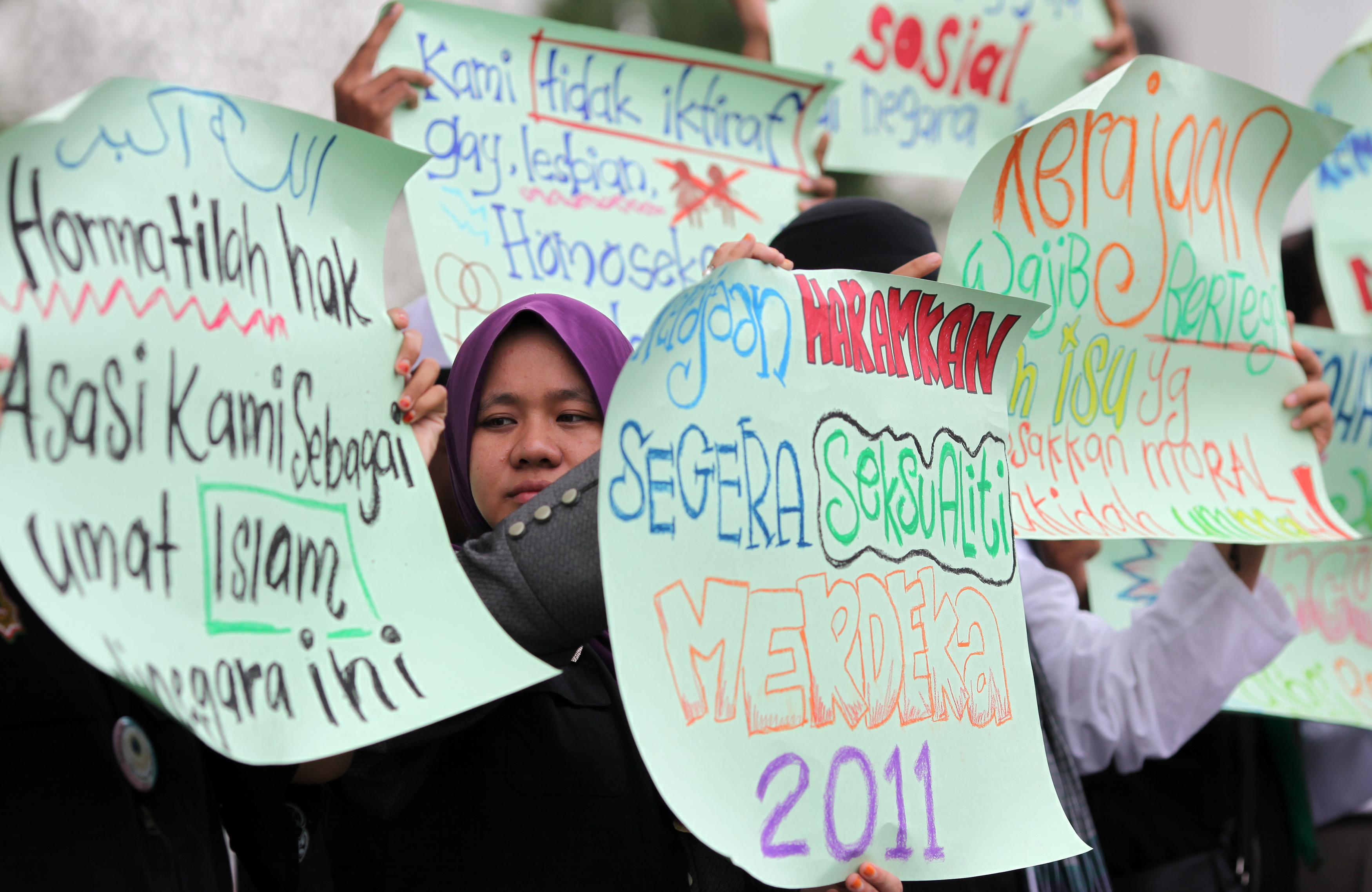 Protesters raise placards during a protest outside a mosque in Shah Alam, near Kuala Lumpur, on Nov. 4, 2011. The demonstration was to urge the government to give recognition to the lesbian, gay, bisexual and transgender community (AFP/Getty Images)