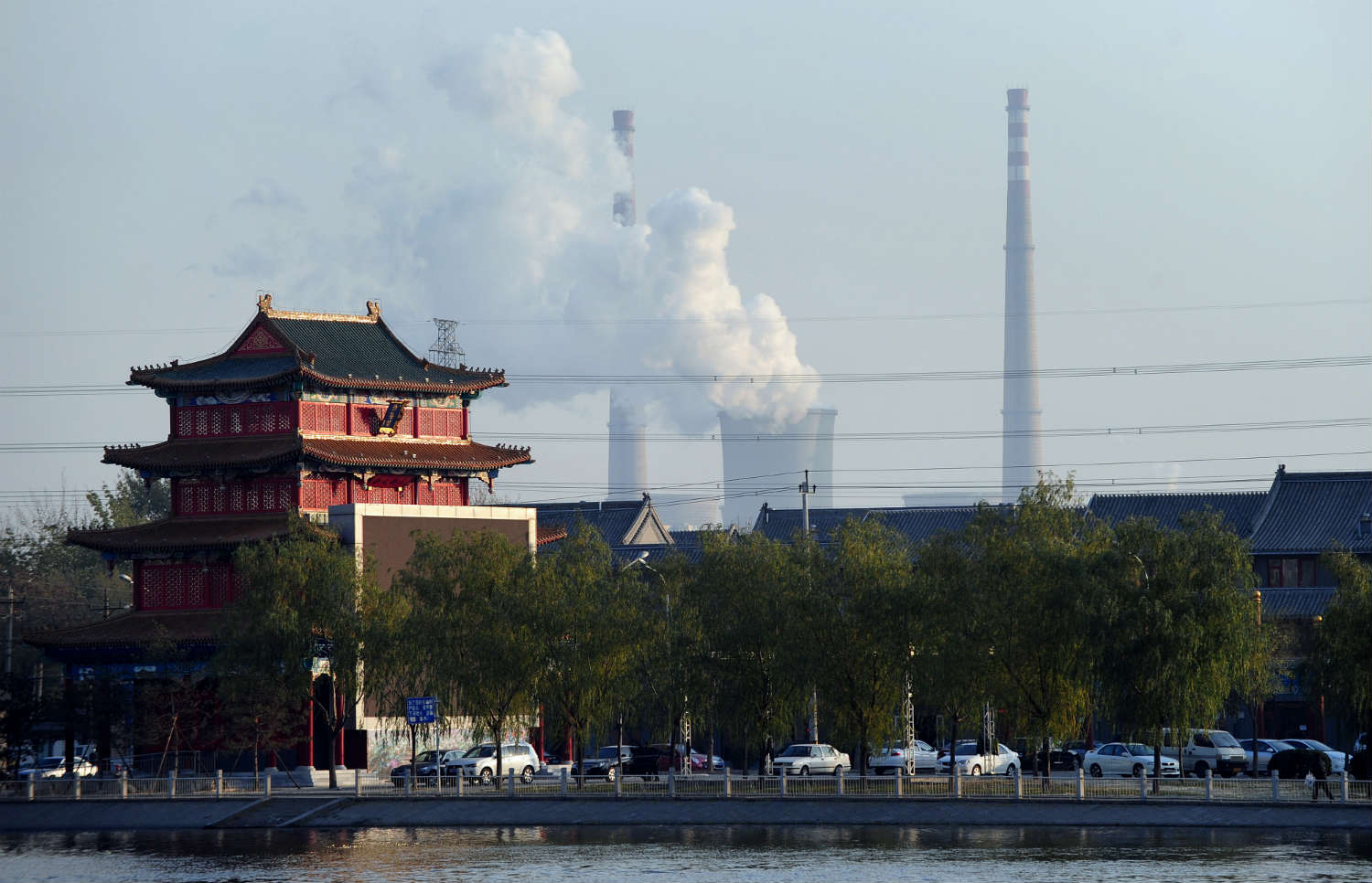 A coal plant looms behind a traditional house in Tianjin, China