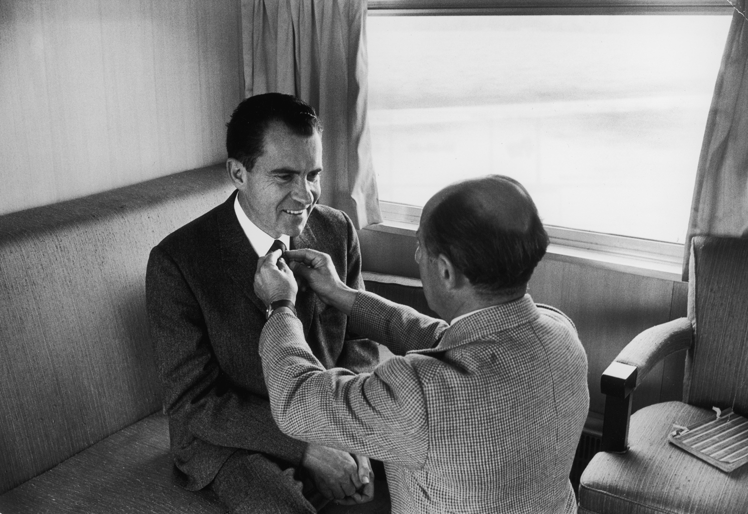 Photographer Alfred Eisenstaedt adjusts Richard Nixon's tie during the 1960 presidential campaign.