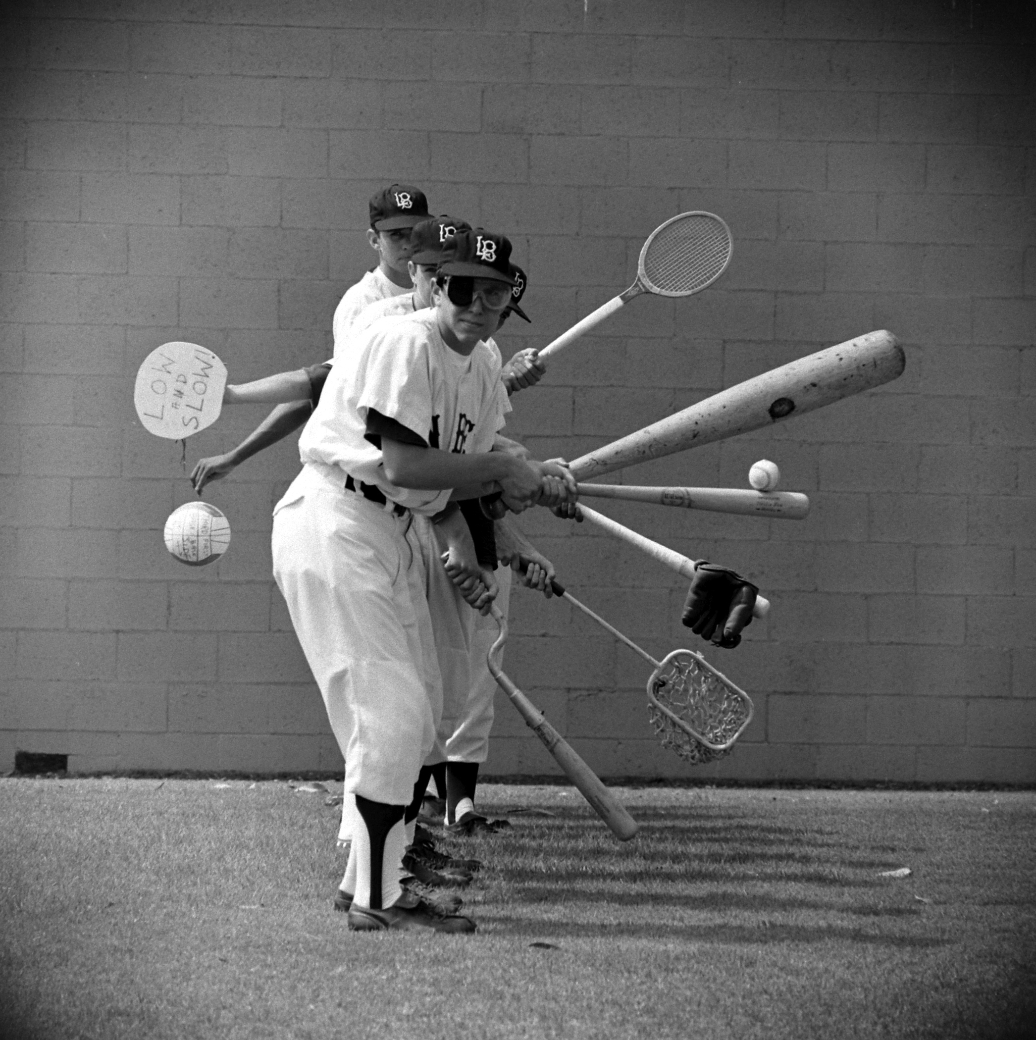 Long Beach Polytechnic High School players practice using unconventional equipment such as tennis rackets, paddles and a volleyball, 1966.