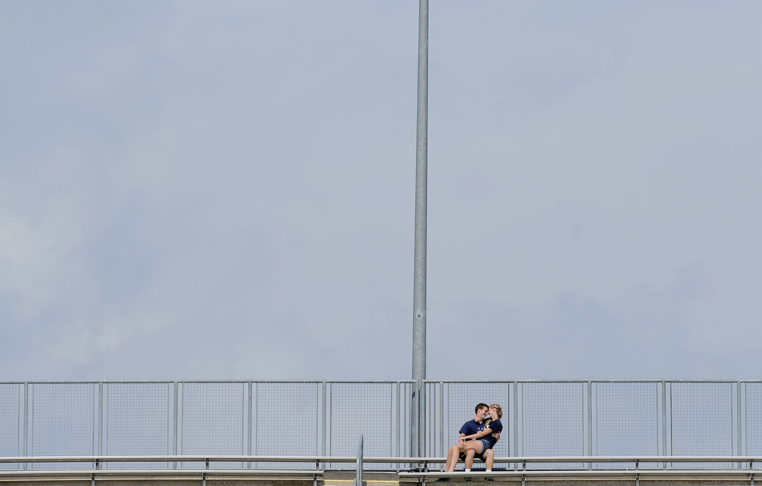 A couple hugs on the bleachers at Rentschler Field during the second half of an NCAA college football game between Connecticut and Stony Brook on Sept. 6, 2014, in East Hartford, Conn.