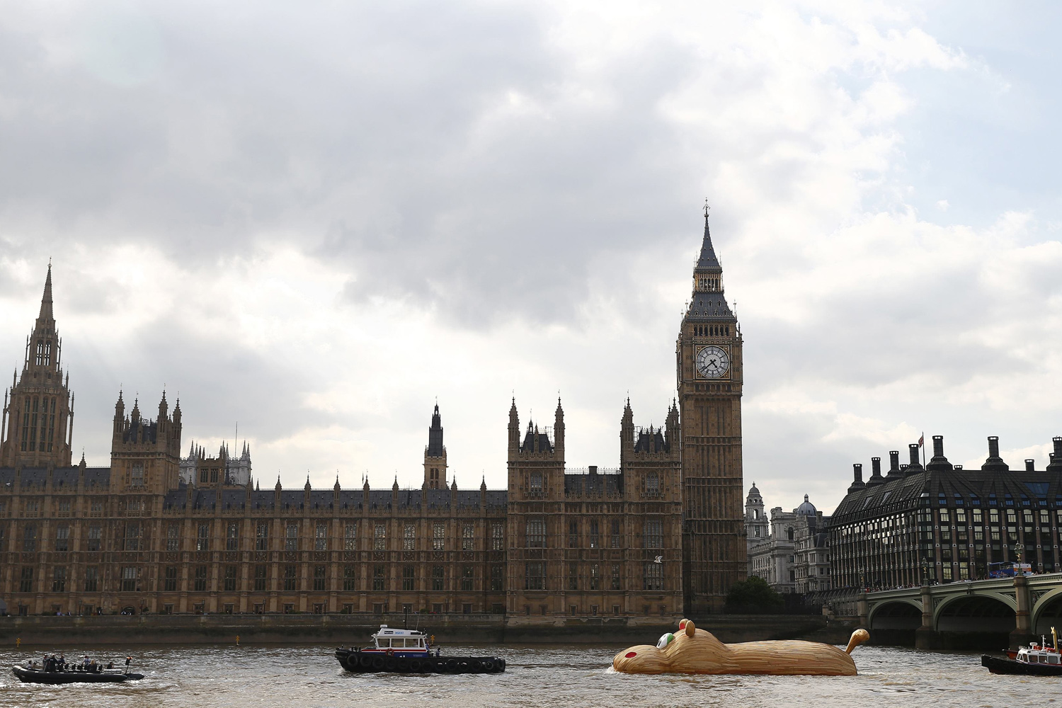 A sculpture of a giant hippopotamus built by artist Florentjin Hofman is towed up the Thames past the Houses of Parliament in central London